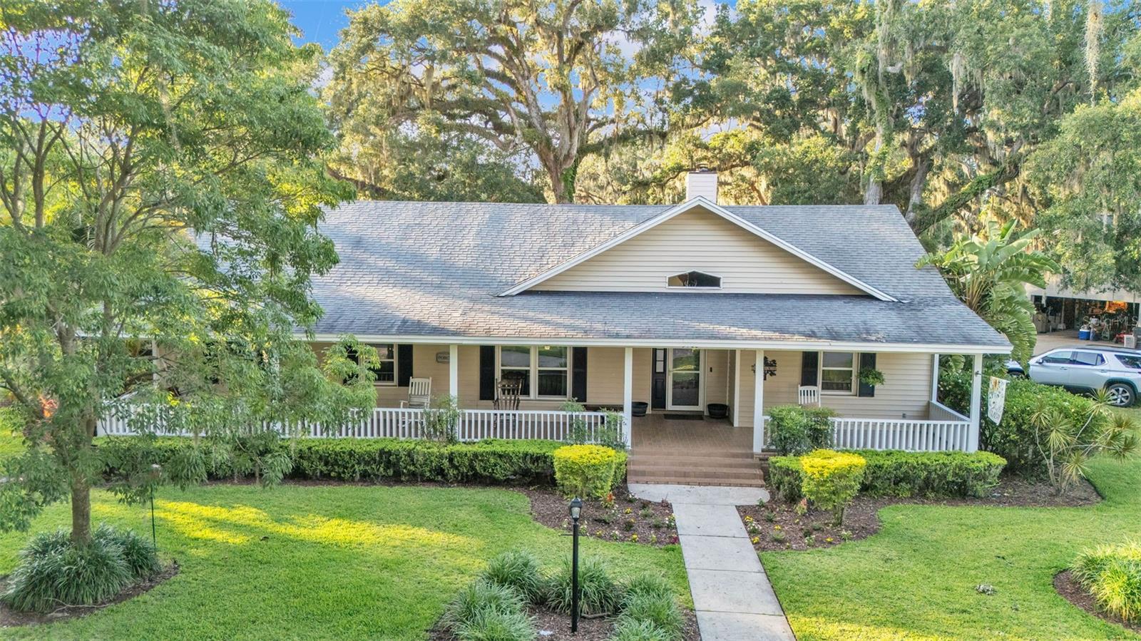 MOTIVATED SELLERS! This 3-bedroom, 2-bath home situated on a spacious 0.72-acre lot with no HOA in the desirable Waterwood subdivision. A long, welcoming front porch invites you inside to a bright split floor plan featuring vaulted ceilings, an open living area with a fireplace, and a separate dining room. The kitchen provides ample cabinet storage along with a cozy breakfast nook. Outdoor living shines with a large back patio, vinyl-fenced backyard, and a screened porch off the primary bedroom—perfect for morning coffee or unwinding in the evening. The home is connected to a separate well for irrigation, keeping lawn care easy and utility costs low. Bonus space alert! The property features a 2-car garage, with one side currently enclosed and under A/C, being used as a flexible 4th bedroom. This area is not counted in the heated square footage but offers great versatility and can be converted back to a full 2-car garage if desired. There's plenty of parking with an oversized circular driveway. Conveniently located near the Polk Parkway, Fort Fraser Trail, schools, shopping, and a nearby public boat ramp.