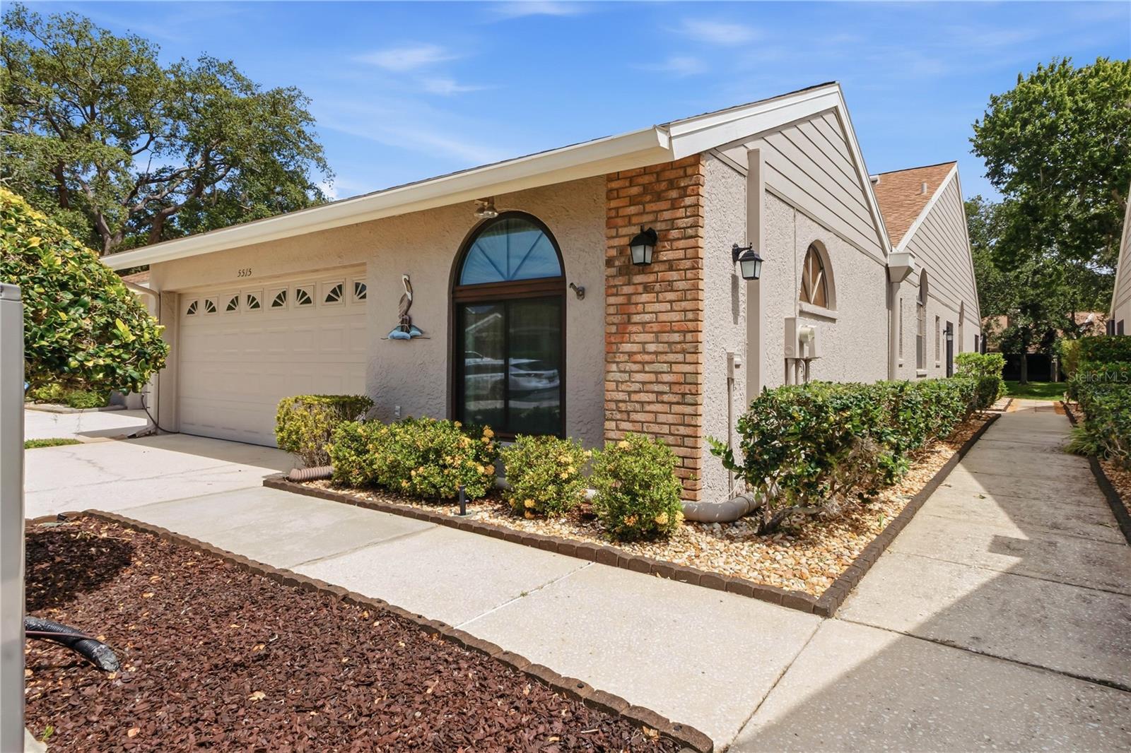 Enjoy perfect blend of comfort and convenience in this meticulously maintained 2-bedroom + den, 2-bathroom, 1659 square foot maintenance free villa with a 2-car garage, located in the highly sought-after Salem Square subdivision of Ridgemoor in the East Lake corridor. This home features an expanded kitchen with ample counter space, custom backsplash designed for both style and function, complete with newer stainless-steel appliances, convection oven, corian countertops, wood cabinets with pull outs, center island with storage perfect for the chef in the family. Enjoy your meals in the spacious dining room and extend your living space outdoors to the centrally located atrium that fills the home with natural light, creating a warm and inviting space. The split-bedroom floor plan offers privacy, with upgraded en-suite primary bedroom w/sliders overlooking the serene pond serving as a relaxing retreat with a large spacious walk-in closet w/built California closet shelving. The primary bath features upgraded cabinets, dual marble sinks, soaker tub & separate shower. Additional features include a large screened in pavered patio, perfect for entertaining family & friends and watching the wildlife on the peaceful pond. Engineered hard wood floors in the huge family room/living room, 23 x23 custom tile in the entrance and on into the kitchen, a den with laminate floors could easily be turned into a 3rd bedroom. The spacious guest suite with laminate floors and ample closet space is located to the front of the villa. Guest bath is nicely appointed with tub & shower, upgraded cabinets, lighting, corian sink & fixtures. Located in a maintenance-free community, you’ll enjoy the benefits of carefree living in the highly desirable Salem Square neighborhood, complete with proximity to shopping, and dining. Salem Square is a gated community, offering a prime location for outdoor activities including the Pinellas Trail and a short distance to John Chesnut Park with boat launch for access to Lake Tarpon. Enjoy the sparkling community pool just seconds away, playground, basketball and tennis courts and plenty of sidewalks for your Florida sunshine enjoyment. Minutes to the best beaches in America.