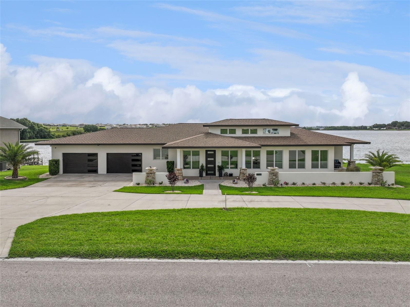 Custom-built in 2015 by Hulbert Homes and inspired by Frank Lloyd Wright design principles, this exceptional lakefront residence on Lake Tennessee offers refined architecture, thoughtful updates, and sweeping water views. Nearly every bedroom and room in the home overlooks the lake, creating a serene backdrop throughout the property.

Showcasing over 20 stained glass windows by Anderson Glass Company, the home is filled with character and natural light. Interior features include quartz countertops, 8-foot doors, and ceiling heights ranging from 9 to 15 feet. Most of the home has been updated inside and out, blending timeless design with modern comfort.

The outdoor living space is equally inviting, featuring a heated pool overlooking the lake, a private dock with power, and beautiful sunrise views from the backyard. Additional highlights EV hookup in the garage, and no HOA.