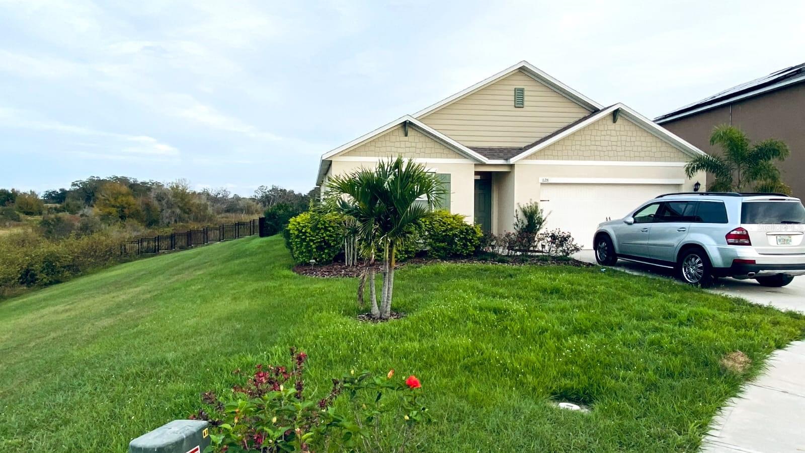Act fast—this move-in-ready Davenport home will not last! Located at 1128 Fox Path Road, this 4-bedroom, 2-bath home offers 1,867 square feet, an open layout, modern kitchen, stainless-steel appliances, and peaceful lake and conservation views. Enjoy a screened porch, fenced backyard, two-car garage, and community pool, all near shopping, dining, highways, and Central Florida attractions.
