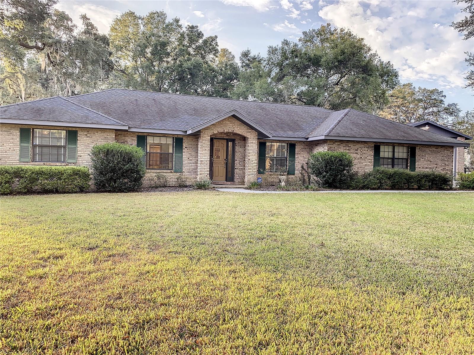 Welcome to your dream retreat! This inviting home eagerly awaits you, and it's perfect for those who love to bring their toys along for the ride. Imagine having a 24 X 40 RV garage, an additional detached 16 X 37 garage (currently a charming workshop), and a convenient attached garage measuring 21 X 26 – all at your disposal. Nestled in a wonderfully private location, this residence opens its doors to a lifestyle of leisure and relaxation. Picture yourself unwinding by the inviting inground pool or spending delightful evenings on your screened lanai. Every corner of this property has been designed with your comfort in mind. Step inside, and you'll discover a haven of spaciousness. The living room welcomes you with a cozy fireplace and a lofty cathedral ceiling, creating a warm and inviting atmosphere. A dedicated dining room, a convenient office space, and a Florida room with a delightful view of the pool offer a variety of spaces to suit your lifestyle. You'll find elegant tile throughout, enhancing the flow of the home, while the bedrooms offer a plush carpet for added comfort. Outside, the property is adorned with lush landscaping, creating a picturesque backdrop for your daily adventures. A three-board fence encircles the property, providing both a sense of security and a charming aesthetic. This home is not just a residence; it's an invitation to a lifestyle where every day feels like a vacation. Come and experience the warmth and welcoming embrace of this property, where the possibilities are as vast as the sky. Your dream home is ready – bring your toys and make it your own!