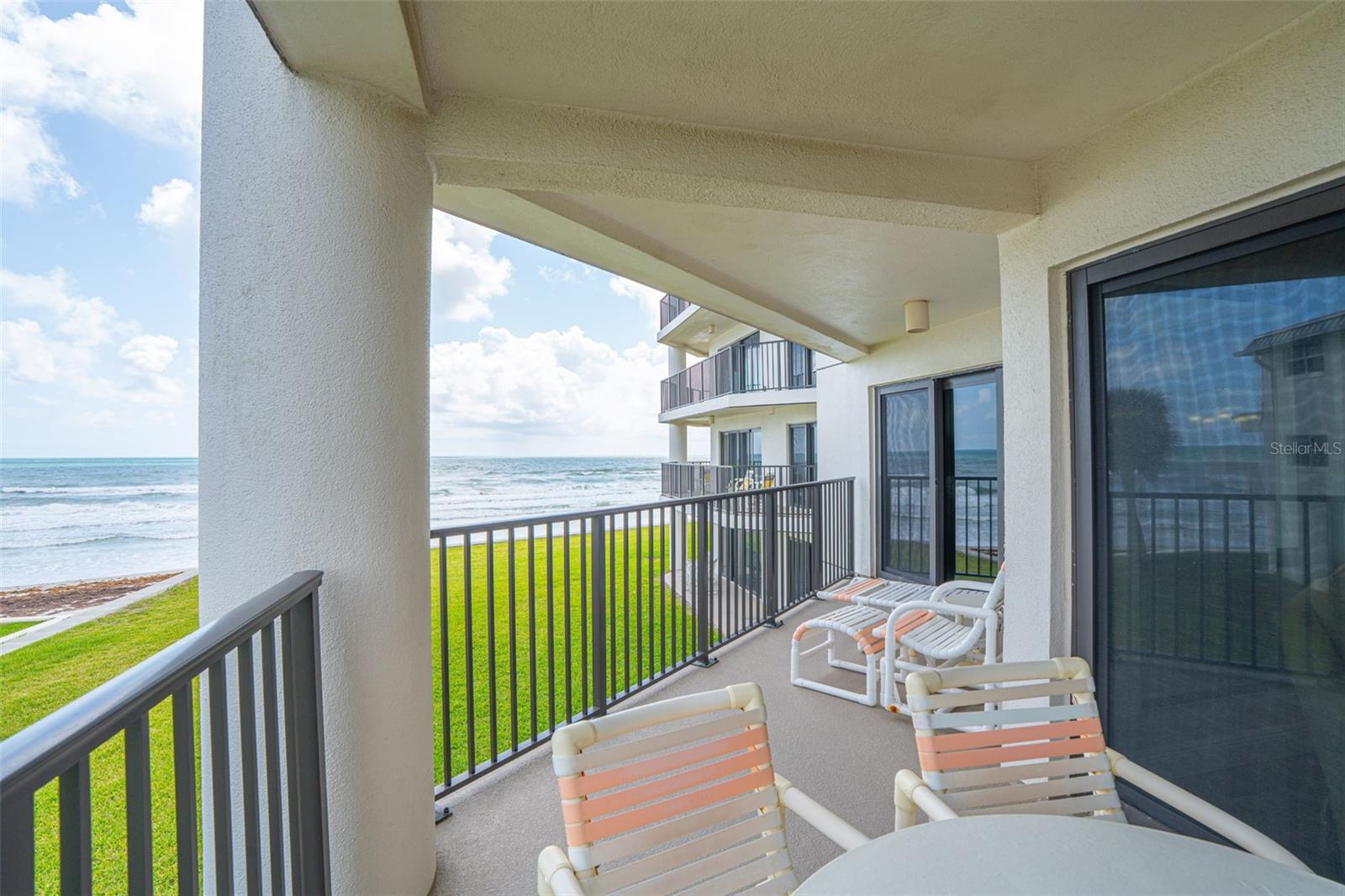 Welcome to your slice of paradise at Silver Sands Condominiums, ideally located on the highly desirable no-drive section of New Smyrna Beach. This beautifully appointed 2-bedroom, 2-bathroom beachfront condo offers the perfect blend of coastal charm and modern comfort. Upon entering, you’ll find a guest bedroom and full bath immediately to the right, providing privacy and convenience for family or visitors. The condo then opens into a spacious kitchen, dining, and family room combination designed for easy living and entertaining. The kitchen features stainless steel appliances, ample cabinetry, and generous counter space, all flowing seamlessly into the main living area. Just off the living space is the large primary suite with its own private bath, creating a peaceful retreat. Heavy-duty hurricane-impact sliding glass doors line the living room and primary suite, opening to a wrap-around balcony with breathtaking ocean views and inviting in natural light and coastal breezes. Silver Sands has recently undergone a comprehensive structural enhancement project, including roof, balcony, concrete, and seawall restoration, offering added peace of mind and long-term integrity. Community amenities include an oceanfront pool, tennis courts, poolside restrooms, private beach access, on-site management, elevators, and a stunning indoor atrium with waterfalls at the center of the building. Conveniently located near restaurants, shopping, and all that New Smyrna Beach has to offer, this condo is ideal as a full-time residence, vacation getaway, or short-term rental investment opportunity. Experience true beachfront living where every day feels like a vacation.