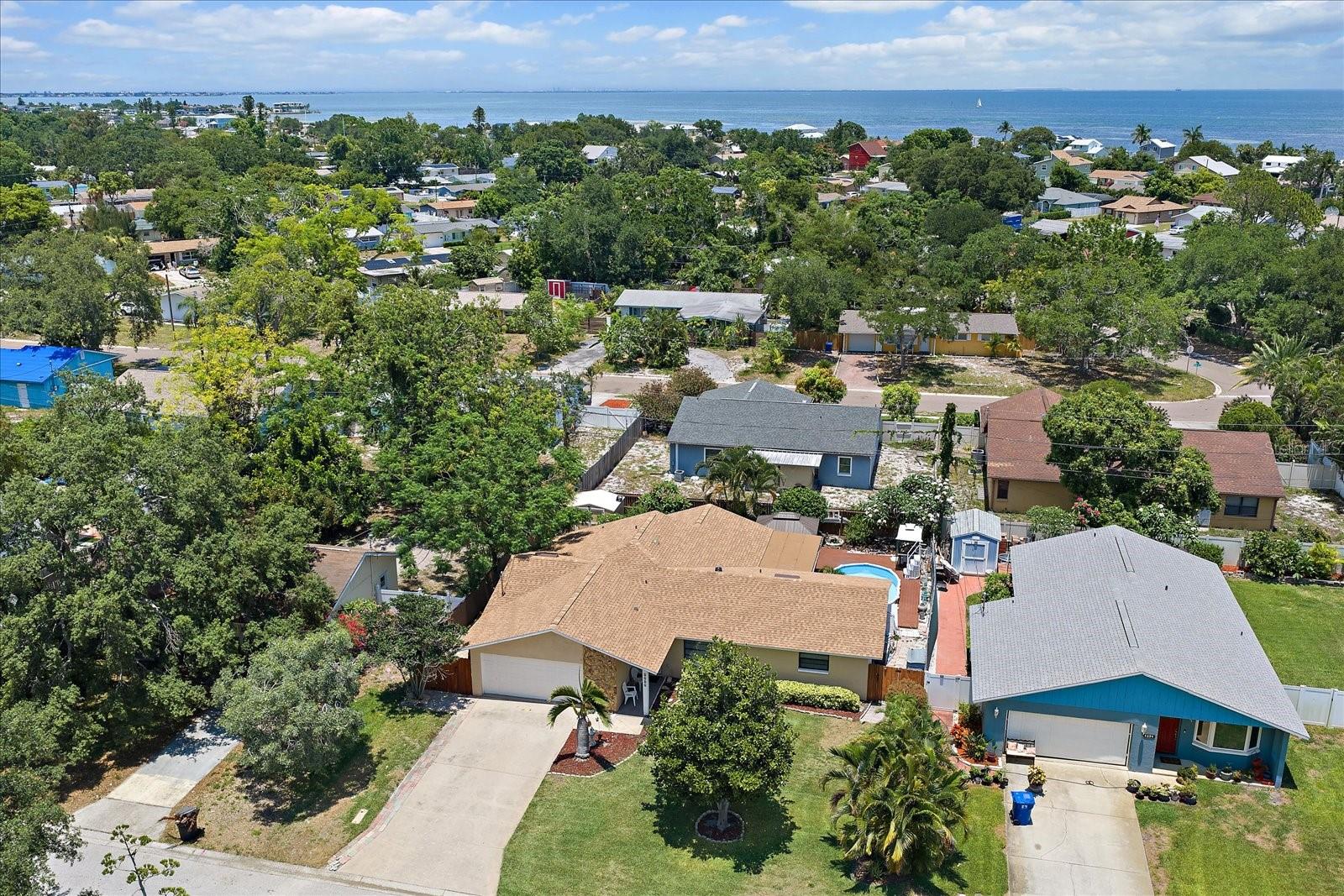 THE OPPORTUNITY YOU HAVE BEEN WAITING FOR ON LEWIS ISLAND IN THE HEART OF COQUINA KEY! This solid concrete block 3-bedroom, 2-bath residence offers the perfect combination of location, major system updates, and outstanding value-add potential.
Step inside and discover a spacious, light-filled floor plan featuring a desirable split-bedroom layout, open living and dining areas, and a generously sized primary suite complete with a private bath and walk-in closet. The home's major improvements have already been completed, including a NEW ROOF (2025), HVAC SYSTEM (2021), and IWINDOWS AND DOORS (2022), allowing the next owner to focus on personalizing the interior and building instant equity.  Situated on a generous 7,684-square-foot lot in FEMA Flood Zone X, this property requires no mandatory flood insurance, providing significant long-term savings and peace of mind. Even more impressive, the home remained completely dry during recent hurricane seasons and has no history of flood damage.  Outdoor living shines here. The screened lanai overlooks an above-ground pool and opens to a beautifully landscaped backyard retreat featuring lush green space, winding brick pathways, a gazebo, paved patio, and storage shed. Whether you're hosting family gatherings, grilling with friends, gardening, or simply relaxing outdoors, this private backyard offers endless possibilities.  The oversized two-car garage has been partially converted with built-in storage and workspace improvements. While the current configuration does not accommodate vehicle parking, it can be reconfigured to meet the new owner's needs.
Located just minutes from vibrant downtown St. Petersburg, waterfront dining, Lassing Park, marinas, shopping, entertainment, and the renowned Central Avenue arts district, this property delivers exceptional convenience and lifestyle.  Whether you're a homeowner seeking a prime location with room to add value or an investor looking for a compelling opportunity, this is a property you won't want to miss. Sold strictly As-Is. Schedule your private showing today before this Lewis Island gem is gone.