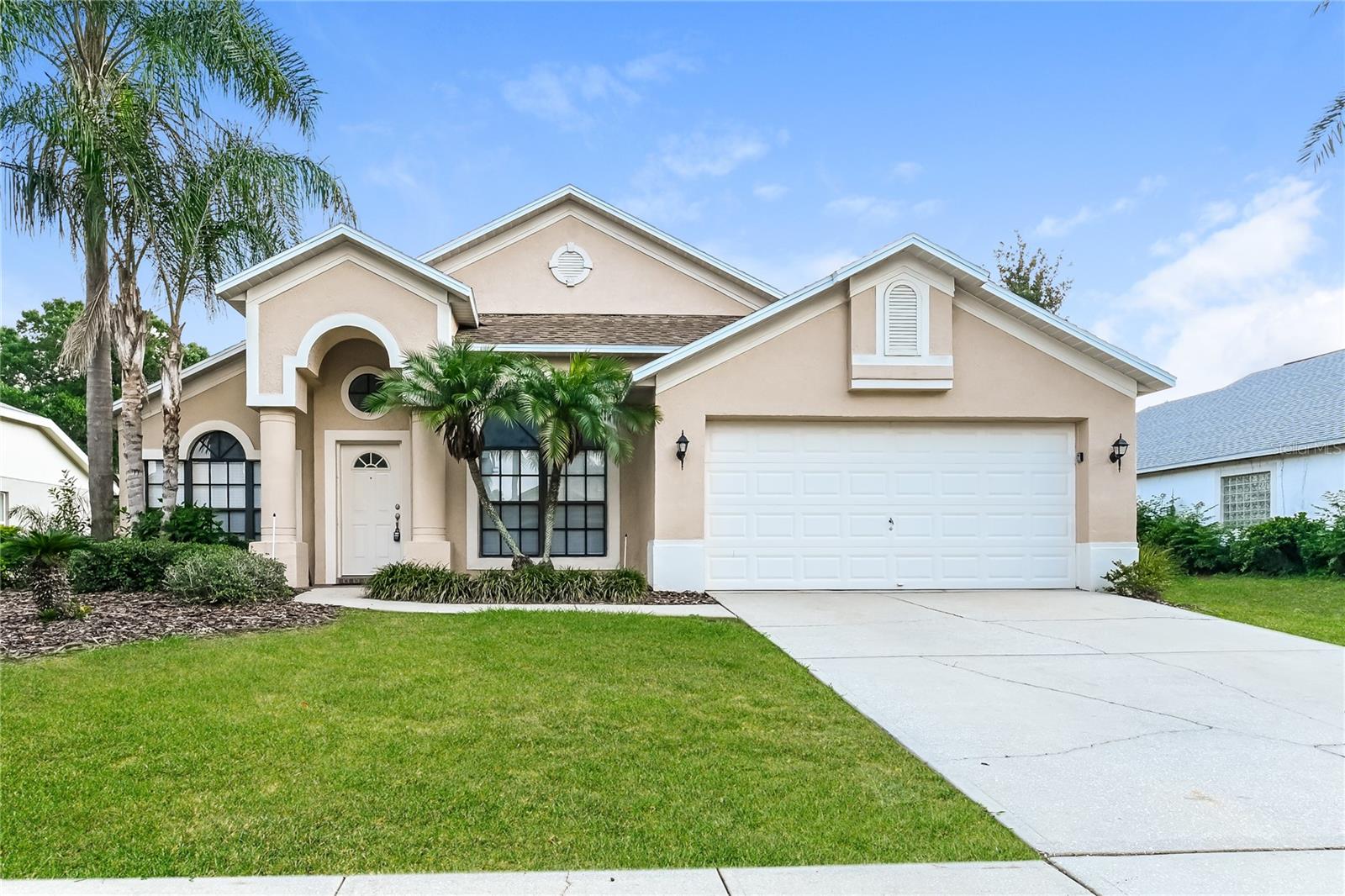 Welcome to this spacious 3/2 home in Brentwood Hills featuring an open, functional layout with high ceilings and plenty of natural light. The kitchen offers ample cabinet and counter space and stainless steel appliances. The primary suite includes private access to the backyard and an en-suite bath with dual vanities, a garden tub, and separate shower. Durable tile flooring runs throughout the main living areas, with vinyl in the bedrooms. Sliding glass doors lead to a covered, screened lanai overlooking the spacious backyard. Complete with a 2-car garage and great curb appeal, this home is ready for its next owner. Easy to show!