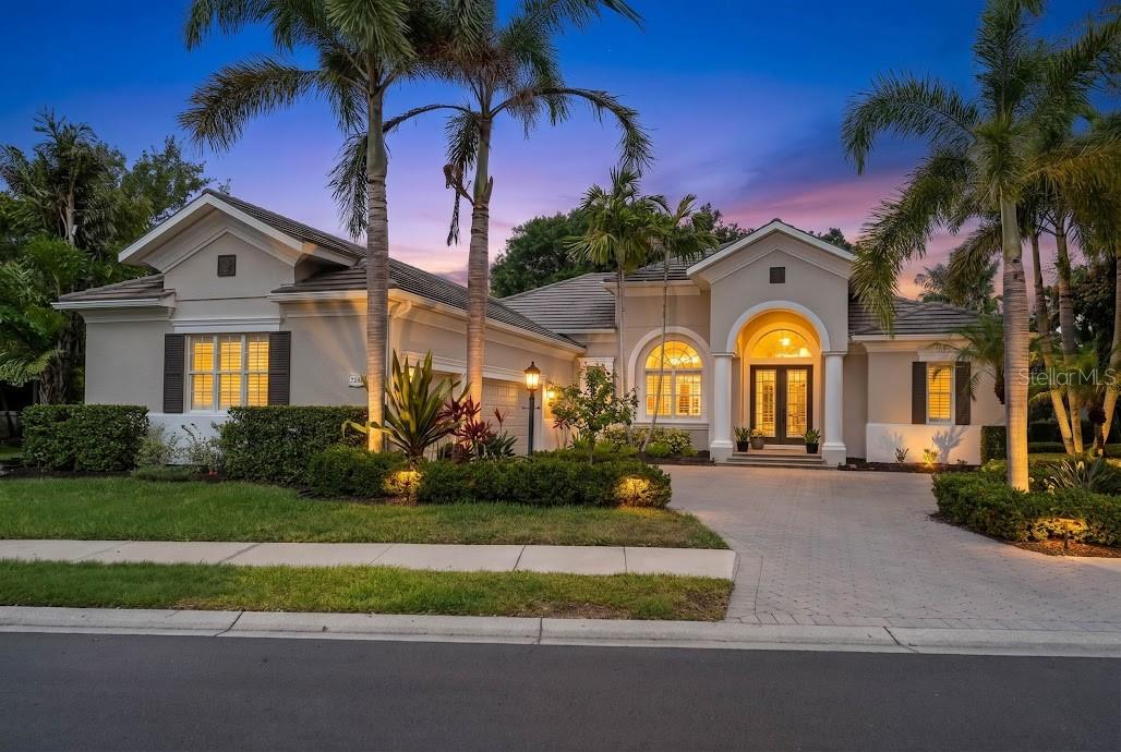 Perfectly positioned on one of Greystone’s most desirable maintenance-free homesites within Lakewood Ranch Country Club, this custom-built residence offers breathtaking water, preserve, and golf course views along with an exceptional combination of luxury, privacy, and functionality.

Featuring 4 bedrooms, 4 full bathrooms, 2 dedicated offices/den/flex room, a spacious loft/bonus room, and an oversized 3-car garage, this thoughtfully designed floor plan provides flexibility for working from home, multigenerational living, and entertaining guests.

A paver driveway and elegant French door entry welcome you into a light-filled interior showcasing soaring ceilings, plantation shutters, European oak engineered hardwood flooring, porcelain tile, custom built-ins, and designer finishes throughout. Expansive windows frame picturesque views while filling the home with natural light.

The chef’s kitchen is designed to impress with Cambria quartz and granite countertops, custom cabinetry with soft-close drawers and pull-outs, under-cabinet lighting, a center island, butler’s pantry, walk-in pantry, and premium appliances. The adjacent family room and breakfast nook overlook the heated pool, expansive screened lanai, and stunning natural surroundings beyond.

The private owner’s suite serves as a peaceful retreat with custom closet systems and a spa-inspired bath. Upstairs, a guest bedroom, full bath, and large loft/bonus room create the perfect private space for visitors, recreation, or a media room.

Designed to embrace Florida’s indoor-outdoor lifestyle, the expansive screened lanai offers multiple covered entertaining areas, a large heated pool, and panoramic views of the lake, preserve, and golf course. Mature landscaping provides exceptional privacy while maintaining the beauty of the surrounding scenery.

Extensive recent improvements provide outstanding peace of mind, including three new Ruud multi-stage HVAC systems with advanced filtration, UV microbe management, and transferable warranties (2026), a new pool filter (2026), Titan whole-home water filtration and softening system (2024), new pool pump (2024), ChargePoint Level 2 EV charger, updated garage door openers with WiFi connectivity, refreshed interior finishes and upgraded lanai screens and hardware. CDD Bond is paid off. 
Residents enjoy a truly maintenance-free lifestyle with lawn care, cable, internet, and gated security included through the HOA, along with optional Lakewood Ranch Country Club memberships offering championship golf, tennis, fitness, dining, and social amenities.

Ideally located just minutes from University Town Center, I-75, top-rated schools, fine dining, shopping, and world-renowned Gulf Coast beaches, this exceptional property presents a rare opportunity to enjoy luxury living in one of Lakewood Ranch’s most sought-after communities.