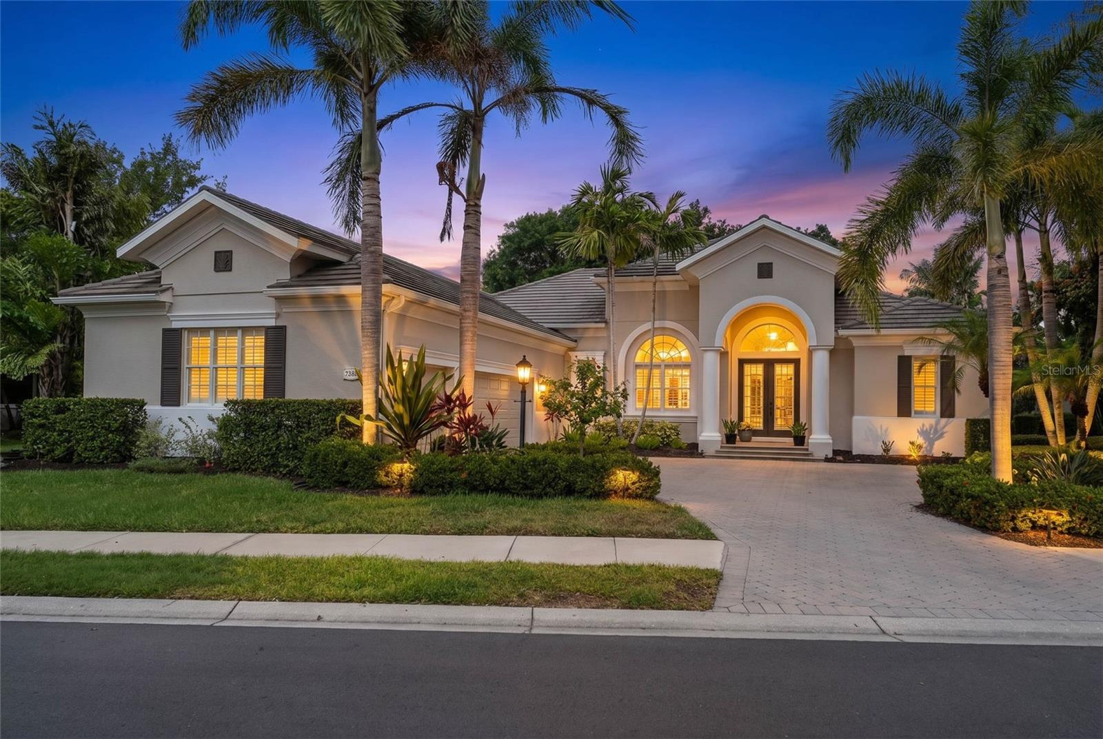 Perfectly positioned on one of Greystone’s most desirable maintenance-free homesites within Lakewood Ranch Country Club, this custom-built residence offers breathtaking water, preserve, and golf course views along with an exceptional combination of luxury, privacy, and functionality.

Featuring 4 bedrooms, 4 full bathrooms, 2 dedicated offices/den/flex room, a spacious loft/bonus room, and an oversized 3-car garage, this thoughtfully designed floor plan provides flexibility for working from home, multigenerational living, and entertaining guests.

A paver driveway and elegant French door entry welcome you into a light-filled interior showcasing soaring ceilings, plantation shutters, European oak engineered hardwood flooring, porcelain tile, custom built-ins, and designer finishes throughout. Expansive windows frame picturesque views while filling the home with natural light.

The chef’s kitchen is designed to impress with Cambria quartz and granite countertops, custom cabinetry with soft-close drawers and pull-outs, under-cabinet lighting, a center island, butler’s pantry, walk-in pantry, and premium appliances. The adjacent family room and breakfast nook overlook the heated pool, expansive screened lanai, and stunning natural surroundings beyond.

The private owner’s suite serves as a peaceful retreat with custom closet systems and a spa-inspired bath. Upstairs, a guest bedroom, full bath, and large loft/bonus room create the perfect private space for visitors, recreation, or a media room.

Designed to embrace Florida’s indoor-outdoor lifestyle, the expansive screened lanai offers multiple covered entertaining areas, a large heated pool, and panoramic views of the lake, preserve, and golf course. Mature landscaping provides exceptional privacy while maintaining the beauty of the surrounding scenery.

Extensive recent improvements provide outstanding peace of mind, including three new Ruud multi-stage HVAC systems with advanced filtration, UV microbe management, and transferable warranties (2026), a new pool filter (2026), Titan whole-home water filtration and softening system (2024), new pool pump (2024), ChargePoint Level 2 EV charger, updated garage door openers with WiFi connectivity, refreshed interior finishes and upgraded lanai screens and hardware. CDD Bond is paid off. 
Residents enjoy a truly maintenance-free lifestyle with lawn care, cable, internet, and gated security included through the HOA, along with optional Lakewood Ranch Country Club memberships offering championship golf, tennis, fitness, dining, and social amenities.

Ideally located just minutes from University Town Center, I-75, top-rated schools, fine dining, shopping, and world-renowned Gulf Coast beaches, this exceptional property presents a rare opportunity to enjoy luxury living in one of Lakewood Ranch’s most sought-after communities.