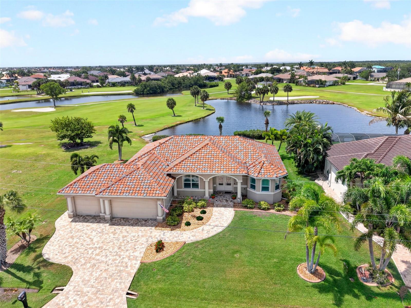 GOLF COURSE & LAKE VIEWS! CUSTOM 3 BEDROOM, 2 BATH, 3-CAR GARAGE POOL HOME IN PUNTA GORDA ISLES!  Imagine waking up to sweeping views across four different fairways, all from the comfort of your private south facing lanai. Situated on one of the finest lots within the Private St. Andrews South Golf Club and positioned perfectly to avoid the noise of tees and greens and tucked away from cart paths and wayward golf balls plus on a no thoroughfare street. Step through the French door entry accented by custom stained glass and be greeted by an open floor plan rich in architectural elegance from the double tray ceilings and crown molding to the 8-foot interior doors and plantation shutters. The living area features a large pocketing slider seamlessly blending indoor and outdoor living. 
The kitchen is a chef’s dream, anchored by an aquarium window in the breakfast nook providing serene morning views. With solid wood cabinetry, granite counters, and stainless appliances including a double cooktop range (2023) and a brand-new dishwasher and microwave (2025), it’s as functional as it is beautiful. 
Retreat to the generous primary suite with slider to pool, walk-in and built-in closets with floor-to-ceiling shelving and private ensuite with three full-size tempered glass windows providing plenty of natural light. 
Step outside to an expansive lanai for entertaining, convenient hot and cold outside shower and screened heated saltwater pool where guests from the north can enjoy an abundance of Florida sunshine. 
The home’s practical side is just as impressive: inside laundry with wood cabinetry and large pantry for extra storage, 3-car garage with an oversized 9-foot door and main electrical panel ready for an emergency generator. You’ll have total peace of mind here. This home has an impeccable hurricane history with no surge flooding or lost roof tiles. It’s been meticulously maintained and upgraded with impact windows, 2024 Storm Smart shutters, a rescreened pool cage, and a brand-new HVAC and water heater (2025). Even the attic has been foam-sealed for peak efficiency.

Positioned in a highly desired community offering quick access to St. Andrews South Golf Club, the Yacht Club, Fishermen's Village, and historic downtown Punta Gorda. This location provides immediate proximity to world-class fishing, boating, fine dining, parks, arts, community events and entertainment.
