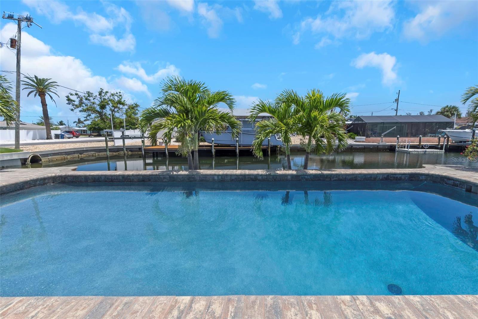 Stop scrolling for the rare, turnkey waterfront paradise you have been waiting for. Nestled on a rare, premium CORNER LOT with OVER 115 FEET OF DEEP-WATER CANAL FRONTAGE, this fully remodeled 3-BEDROOM, 2-BATHROOM 1-CAR POOL HOME delivers the ultimate Florida lifestyle. Launch your boat right from your backyard and be out on the open water in minutes, with the sugar-sand beaches of ANNA MARIA ISLAND and LONGBOAT KEY just a short boat ride or drive away. These waters are highly coveted and famous for world-class fishing. Plus, enjoy an effortless commute with quick access to SRQ AIRPORT and NO REQUIRED HOA.
Step inside to a bright, wide-open SPLIT FLOOR PLAN designed for seamless entertaining. The CHEF-INSPIRED KITCHEN boasts gorgeous QUARTZ COUNTERTOPS, custom cabinetry, and premium GALLERY STAINLESS STEEL APPLIANCES. Retreat to your luxurious PRIMARY SUITE, a private, spa-like oasis featuring DUAL RAINFALL SHOWERS and a stunning FREESTANDING SOAKING TUB.
Host the ultimate weekend barbecues on your oversized PAVER PATIO, take a dip in your PRIVATE POOL, or just sit back and soak in the expansive, wide-canal water views. Skip the headaches of remodeling, as this home is completely TURNKEY with NO FLOODING HISTORY, NO WATER DAMAGE, and major mechanical and structural updates already completed. Features include a NEWER ROOF, NEW HIGH-EFFICIENCY HVAC, NEW WATER HEATER, NEW ELECTRICAL PANEL, and UPGRADED ENERGY-EFFICIENT WINDOWS. This property is even AVAILABLE FURNISHED. Bring your boat, pack your bags, and start living the dream today. VA and conventional financing are welcome. This rare corner-lot offering will not last. Schedule your private tour before it is gone.

DEEP-WATER, MARKED CHANNELS WITH NO HEIGHT RESTRICTIONS, BRING YOUR SAILBOAT OR CENTER CONSOLE.

Seller discloses no knowledge of flood damage, no history of flood insurance, and no prior FEMA claims. A recent independent appraisal came in above asking price. Virtually staged photos are included in the marketing. Buyer and Buyer’s Agent to conduct all due diligence and independently verify all measurements, zoning, facts, and representations. Information deemed reliable but not guaranteed.
POOL IS UNDER REPAIR* IT WILL BE REFILLED AND EQUIPMENT SERVICED UPON COMPLETION.