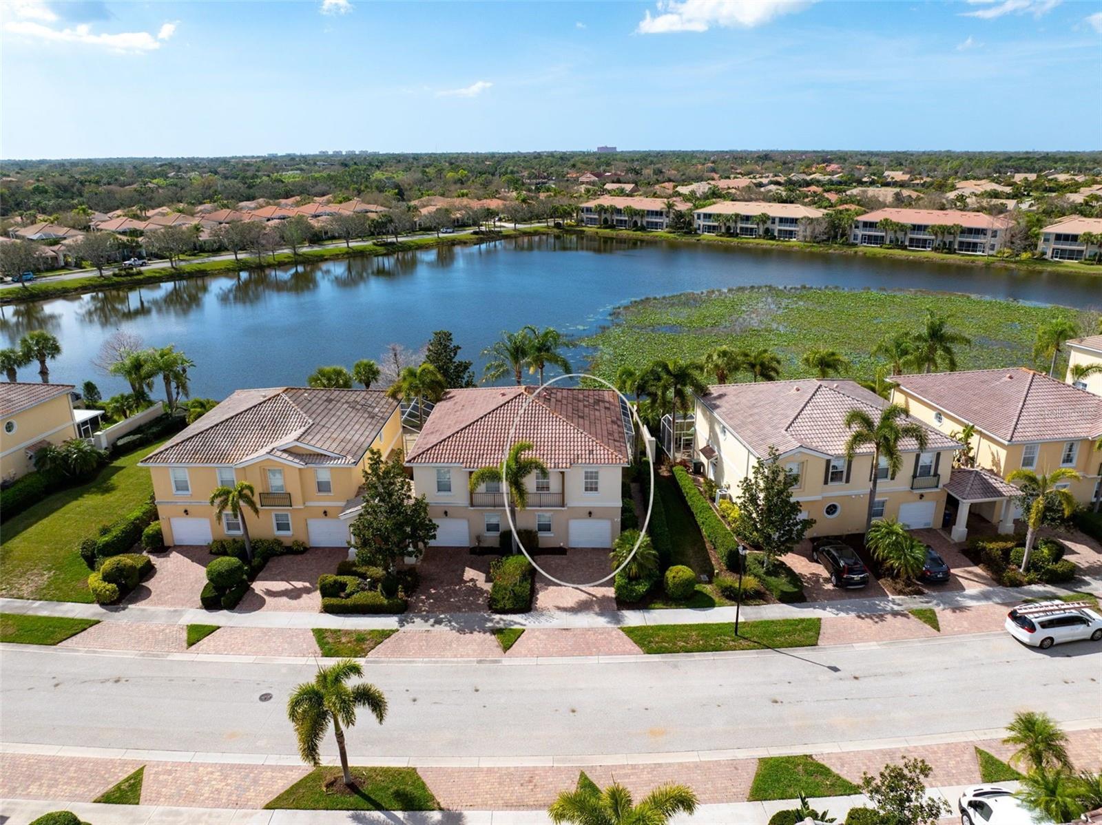 Enjoy easy Florida living in this freshly presented three-bedroom, two-and-a-half-bath Catalina townhome located in the highly sought-after community of The Isles. Bright, clean, and move-in ready, the home offers a comfortable layout designed for both everyday living and relaxed entertaining, all complemented by peaceful lake views that bring a sense of calm to the main living spaces.

Tile flooring throughout the first floor creates a light, low-maintenance environment, while the open great room flows effortlessly toward the outdoor living area, where a spacious screened lanai overlooks the water—a perfect place to enjoy morning coffee or unwind in the evening. The kitchen provides generous cabinetry, Corian countertops, and updated appliances including a newer refrigerator and microwave, with a conveniently located laundry room just steps away offering additional storage.

Upstairs, the primary suite serves as a comfortable retreat with two closets, including a walk-in with built-in organization. The ensuite bath features dual vanities, a soaking tub, and a separate shower. Two additional bedrooms and a shared full bathroom offer flexible space for guests, family, or a home office. Additional upgrades include a newer air-conditioning system (2021), central vacuum, and a security system.

Residents of The Isles enjoy an active, resort-style environment with beautifully maintained grounds and an impressive amenity campus designed for recreation, fitness, and social connection. The community’s convenient Sarasota location places you close to the Legacy Trail, everyday shopping and dining, and the world-famous shores of Siesta Key Beach, making this an exceptional opportunity to enjoy both value and lifestyle in one of the area’s most vibrant neighborhoods.
