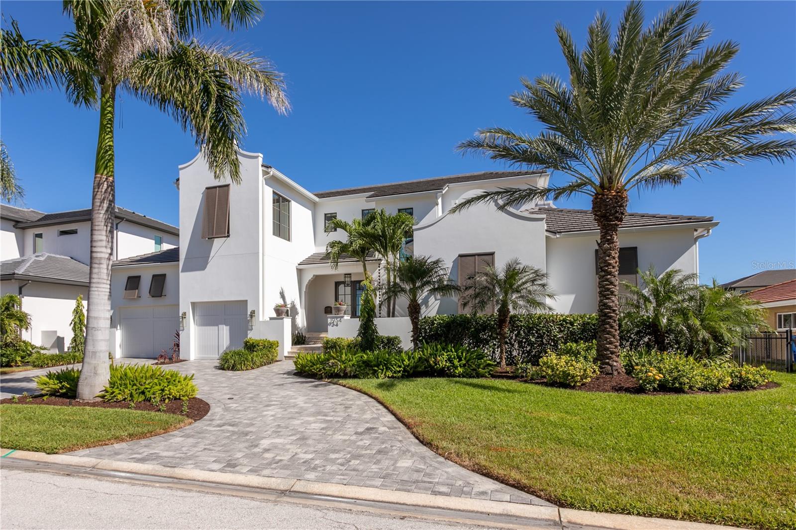 Located near the end of a quiet cul-de-sac in the desirable waterfront community of Venetian Isles, this 2020 custom-built masterpiece by Bright Bay Builders delivers luxury, craftsmanship, and wide-open water access with no bridges to Tampa Bay. Offering 4,472 sq ft of living space the home sits high and secure with no flooding inside and showcases the best of modern coastal design.

Inside, five spacious bedrooms and five full baths (including four en-suites) offer privacy and flexibility for family and guests. The open-concept living area features designer finishes, French oak and cypress flooring, and walls of windows framing stunning views. The gourmet kitchen is equipped with a 48" Sub-Zero refrigerator, Miele crystal dishwasher, Wolf gas range and hood, Wolf microwave, Viking French-door wall oven, and warming drawers, complemented by custom Allikriste cabinetry and striking tilework. A separate game room includes a Marvel beverage center, ice maker, and Danby Pro wine refrigerator.

Outdoors, a private courtyard entry with travertine pavers and fountains leads to a resort-inspired backyard with a saltwater pool featuring glass tile, pebble-sheen finish, a swim-out sun shelf with bubblers, umbrella sleeve, six deck jets, and Hayward “Omni Logic” smart automation syste. The private dock includes two boat lifts, lighting, and direct open-water access to Tampa Bay. Additional highlights include Eden Coast composite garage doors with whisper-quiet openers, keyless entry, and impact-rated construction for peace of mind.

This exceptional Venetian Isles residence offers the ultimate in waterfront living—luxurious, secure, and thoughtfully designed for life on the Bay.