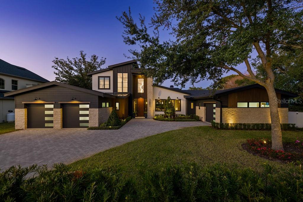 Welcome home to this one-of-a-kind custom-designed and built home by Ferrarini Custom Homes, Inc. in February 2024. This singular mid-century modern home is like no other in Winter Park.  Boasting an ideal location just steps from Phelps Park as well as only 1.5 miles from Park Avenue makes it the ideal home for the most discerning buyer.  Custom features abound in this stunning 4582 sq. ft. masterpiece, including white oak floors, beams, and wood details in most rooms, 5 BRs, and 4.5 BAs.  The first floor features a primary suite and guest suite as well as an office, great room, dedicated bar, dining area, and exquisite kitchen with a secret pass-through door to the scullery.  The second level boasts three generously sized bedrooms and two baths.  Cable wire railing, stone, wood inlay details, custom front door, oversized lanai with summer kitchen, outdoor fireplace, huge pool with firepit and separate firepit conversation area, the list goes on and on...   This unique lot is a rare find in Winter Park - oversized in both width and depth with dimensions of 155’ deep and 143’ wide.  The interior features over 6600 square feet under roof and a 4-car garage with a work-bench area included. 

The outdoor area features a 34-foot patio with a built-in gas grill, gas fireplace, and large-format porcelain pavers.  The remote screen provides you with ease of access to your custom-designed pool with pebbletec, an outdoor shower, and a firepit nestled amongst the landscaping.  The rear yard is completely irrigated and includes a well for irrigation to keep water expenses down significantly.  The custom-designed pool is large for Winter Park, featuring a lounging shelf as well as a 10’ fire feature and swim-out.  The massive deck is adorned with wood-like porcelain pavers with a porcelain coping.

Smart home features in this home include wireless controls for audio, a/c, garage doors, pool equipment, lighting, and exterior cameras. Additionally there is upgraded spray foam insulation, gas appliances (water heaters, fireplaces, washer, range), and an elevation featuring Cultured stone, Hardi Siding, and a Jeldwyn 10’ front entry door.  Herringbone pavers lead you from the cobblestone street to the magnificent front entry.  Buyers will enjoy the extensive landscaping and privacy hedges.  The landscaping is mature for a brand-new home!  Privacy abounds everywhere in this home.  Custom landscape lighting adds to the estate feel of this home.
 
The gourmet kitchen features all Wolf and Sub-zero appliances, which include a Wolf range, Wolf 2cd oven, steam oven, Sharp microwave, Cove dishwasher with custom wood panel, a Sub-zero Refrigerator with custom panel, and a Sub-zero Freezer also with a custom panel.  Disguised between the refrigerator and freezer is a secret hidden door to the scullery.  Exotic countertops abound throughout the house.  Quartzite like you have never seen before is evident in the kitchen and bar.  Antolini Italian marble that was specially treated with “Zerocare Plus” can be found on the kitchen counters and kitchen backsplash. Custom cabinetry throughout the house, featuring white oak.  Additional appliances include 3 beverage refrigerators, 1 wine refrigerator, ice maker, and a secondary 36” refrigerator.  Every detail has been thought-out and implemented for you in this breathtaking home! 

Do not wait - the work has been done for you with NO waiting time for new construction.  This elegant home will not last!