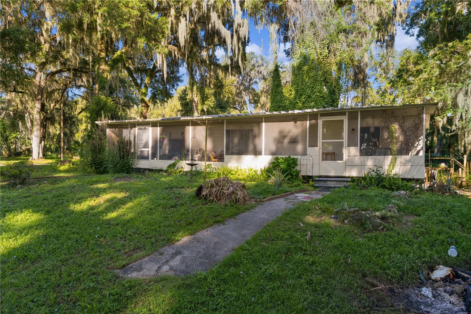 Welcome home to this spacious 3-bedroom, 2-bath manufactured home with a dedicated study/den, perfectly situated on a generous 0.315-acre corner lot with beautiful views of Lake Panasoffkee. Whether you're looking for a full-time residence, weekend retreat, or investment opportunity, this property offers plenty of space both inside and out.

One of the standout features is the enormous covered, screened-in porch that stretches the full length of the home—an ideal place to enjoy your morning coffee, entertain family and friends, or simply relax while taking in the peaceful lake views and Florida breezes.

Inside, you'll find a comfortable floor plan with a versatile study/den that can serve as a home office, hobby room, or guest space. The convenient interior laundry room adds everyday functionality, while the spacious corner lot provides plenty of room for gardening, outdoor activities, or additional storage.

Enjoy the charm of lakeview living with the convenience of nearby shopping, dining, boating, fishing, and recreation. If you've been searching for affordable Florida living with scenic views and plenty of outdoor living space, this is a property you won't want to miss. Schedule your private showing today!
