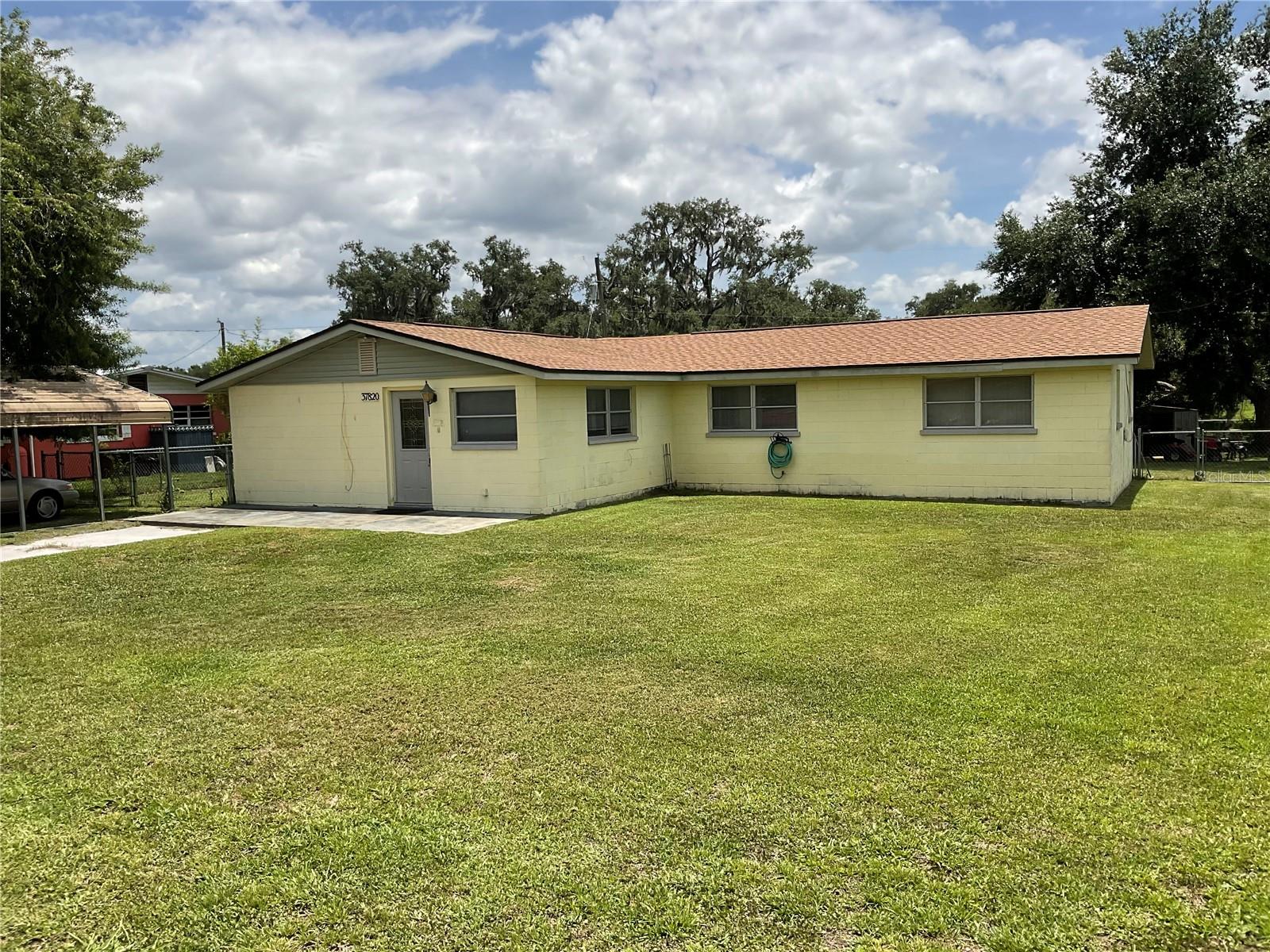 LOTS OF ROOM!! This 4-bedroom property offers .39 acres of comfortable living space. Featuring 4 bedrooms, 2 1/2 baths with newer roof, formal dining, split floor plan, fenced yard, extra attached 1196 sq feet with 1/2 bath, storage, covered deck, inside laundry room, needs some TLC but lots of potential. This property is perfect for modern living. Located in Dade City, you'll enjoy convenient access to local amenities. Don't miss this opportunity to make this house your home. Contact us today to schedule a viewing!
