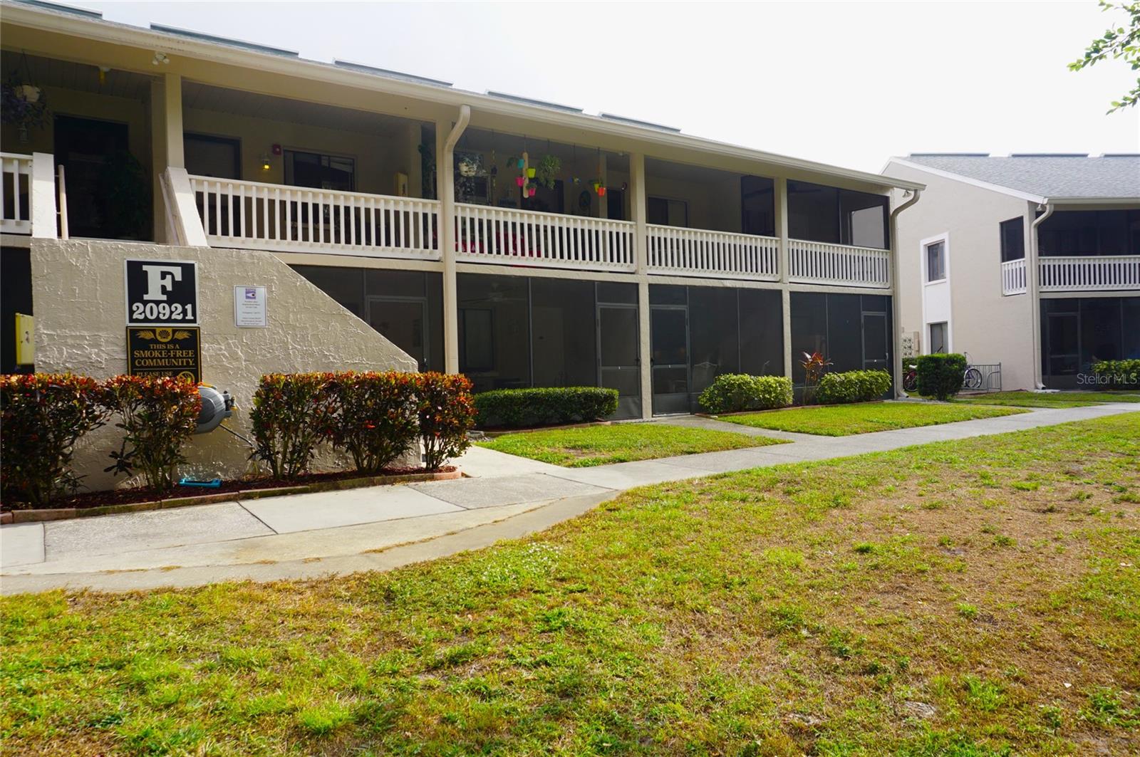 Coveted Ground level condo located in the gated, nudist/clothing-optional community of Paradise Lakes. This lovely home has neutral ceramic tile flooring and colors throughout. The kitchen features a built-in microwave, 2-burner range top, stainless sink, refrigerator, dishwasher, and under cabinet lighting. Updated full bath with tile-surround walk-in shower and glass doors. Bedroom has mirror closet doors, built-in desk, wall-mount TV, and stack washer/dryer for convenience. Spacious living room with comfy sofa bed couch, chair, flat screen TV, dining table & chairs, and mirror accent wall. Enjoy outdoor living with conservation views from the screened covered lanai. Short stroll to the community dock/pier and lake.  Existing furnishings, appliances, decor, amenities included. Buyer is responsible for verifying all information, details, and dimensions. Condo association approval of Buyer is required including application, fee, background check, orientation, and membership in a recognized nudist organization. Optional membership to Paradise Lakes Resort is not included in monthly condo association fee.