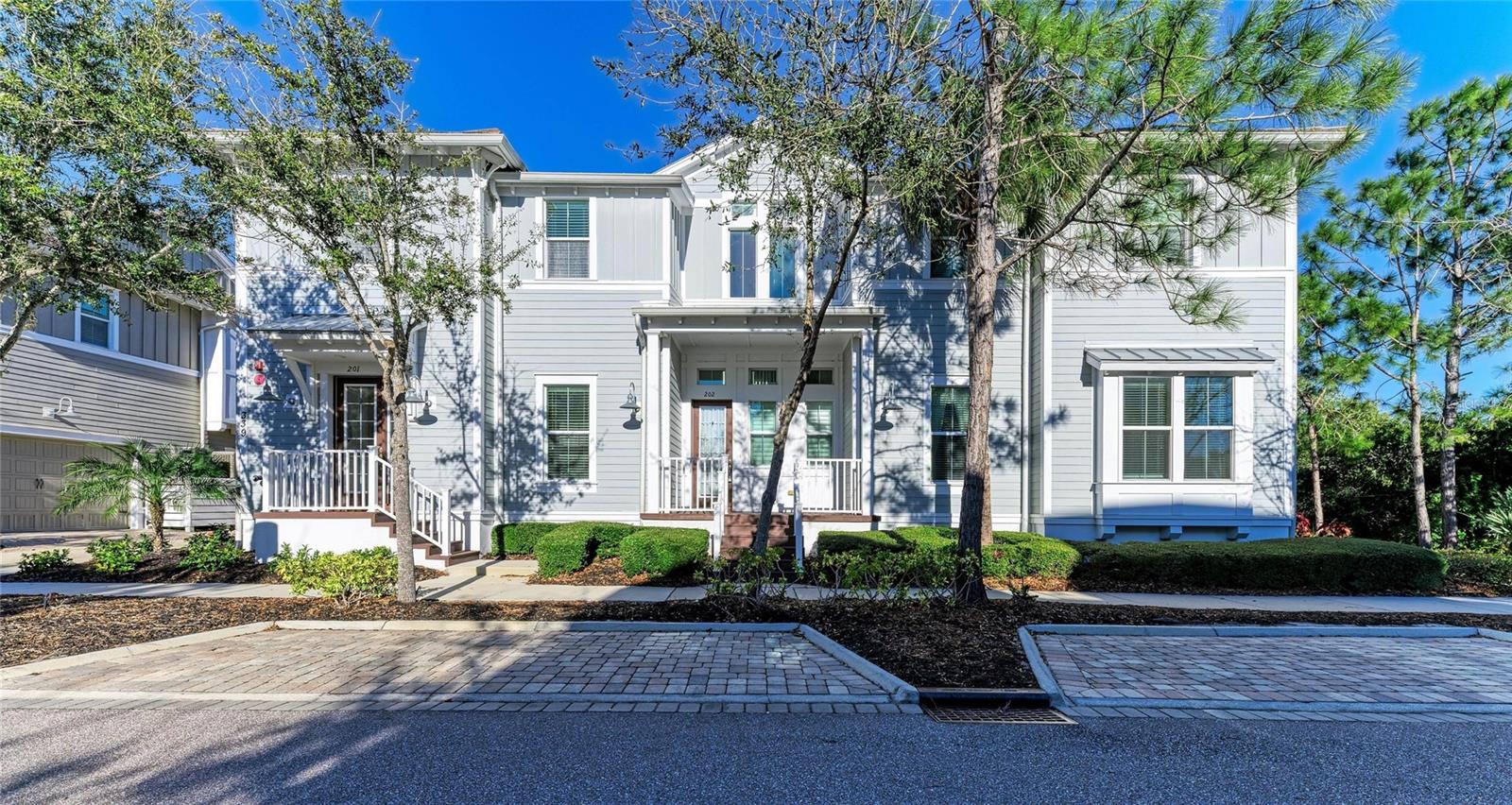 **PRICE IMPROVEMENT**Click the Virtual Tour link for a 4K Fly Through of the home** EXPERIENCE THE BEST OF COASTAL LIVING in this beautiful two-story coach home located within the award-winning gated, waterfront community of Harbour Isle on Anna Maria Sound. Built in 2014, this light-filled 3-bedroom, 3-bath residence blends elegant coastal style with a highly functional layout designed for both everyday comfort & effortless entertaining. Tucked away at the end of the road, this condo enjoys a uniquely peaceful and private location as the final building on the preserve side, with a charming cul-de-sac nearby offering sidewalks, mailboxes, and beautiful lake and nature views. The open-concept living space is filled with natural light, offering seamless sightlines from the kitchen island through the family room into the stunning Florida room where you can enjoy peaceful sunrise views each morning. Family room is inviting & airy featuring soaring ceilings & warm wood-plank detailing. The chef’s kitchen is both stylish & practical, showcasing stainless steel appliances including a NEW KitchenAid refrigerator(2025) & NEW Bosch dishwasher(2025) granite countertops, solid wood custom trimmed cabinetry, glass backsplash, large island with breakfast bar seating and pendant lighting. The split floor plan provides exceptional privacy. The serene primary suite captures beautiful sunrise views and features a spacious walk-in closet with high-end custom cabinetry, along with a spa-like en-suite bath offering dual vanities and an oversized walk-in shower. The guest suite includes its own en-suite bath, while the third bedroom accessed through double doors offers flexibility as a guest room, home office or den. A third full bath is conveniently located off the main living area. Additional highlights include a spacious laundry room with overhead cabinetry for added storage, abundant windows throughout topped off with a PRIVATE ELEVATOR providing effortless access from the 2 car garage to the main living space. Garage features a spacious storage closet. NEW AC handler & condenser(2025). Residents of Harbour Isle enjoy elevated coastal lifestyle centered around a spectacular 23,000 sq. ft. private Beach Club featuring a waterfront Sky Bar, restaurant, resort-style pool and spa, private beach, and kayak launch overlooking Anna Maria Sound. The community offers 4 sparkling pools (including the Mangrove Walk pool), a state-of-the-art fitness center, sauna, fire pits, grilling areas, hammock park, lakeside swings, and miles of scenic walking & biking trails. Steps from Neal Preserve & just minutes from Robinson Preserve offering kayaking, trails, & birdwatching. Just outside the gates are vibrant waterfront destinations including the Margaritaville-inspired Compass Hotel, Floridays Tiki Restaurant, Compass Bar & Chill, & Pier 77 Marina with wet & dry storage, Gulf access & Freedom Boat Club. Only 1–2 miles from the beaches, shops, and dining of Anna Maria Island. Come live the Harbour Isle lifestyle—where coastal charm, resort-style luxury, and unforgettable sunsets define everyday living. Experience one of Florida’s most coveted private communities and claim your own piece of island-inspired living. Schedule your private tour today and start living where others vacation.