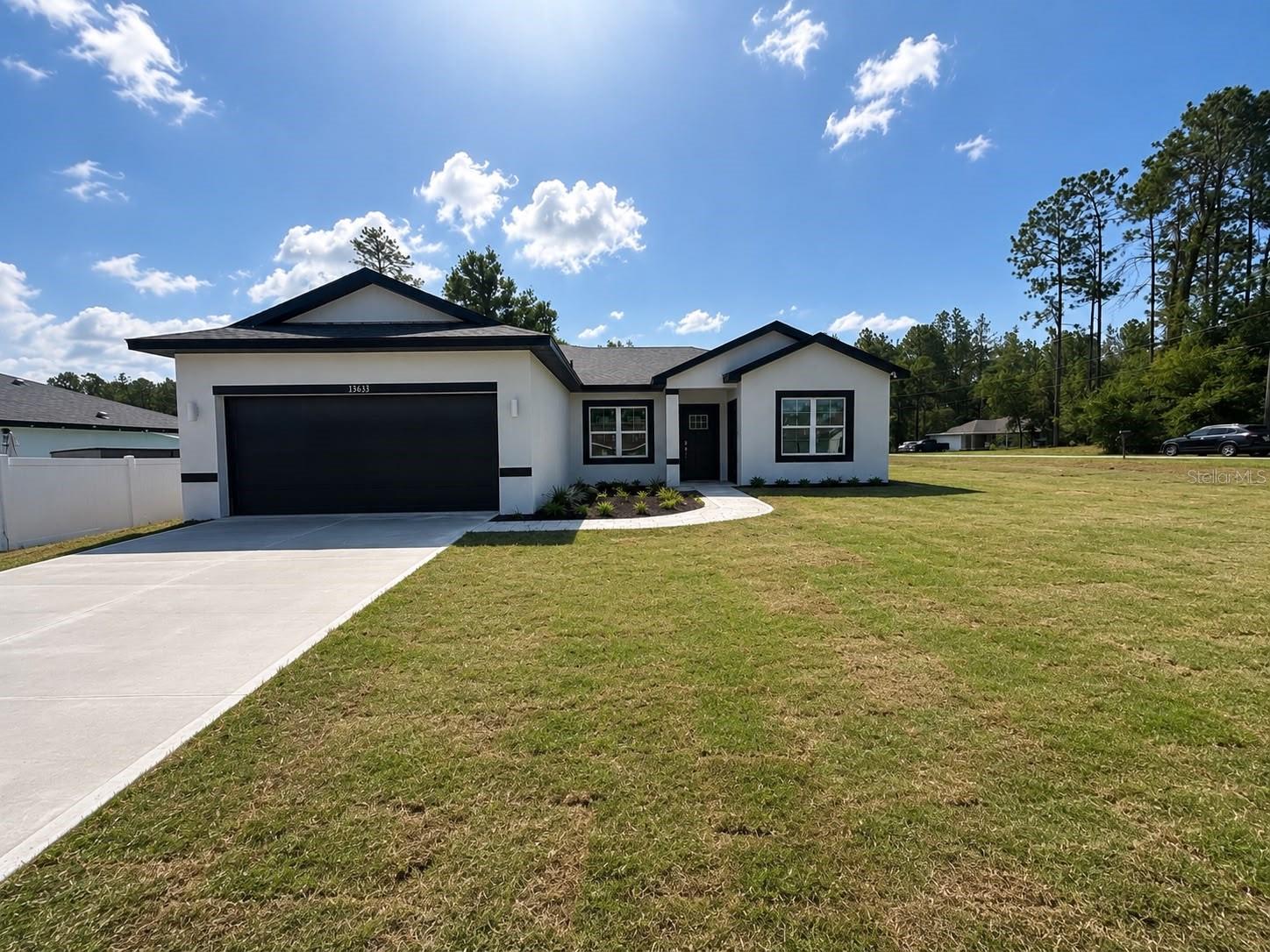 Under Construction. 0.29 ACRES CORNER LOT. BRAND NEW 2026 HOME WITH IN-LAW WITH PRIVATE ENTRANCE IN MARION OAKS! This stunning newly constructed home combines modern living with great income potential, featuring a separate in-law suite with 1 bedroom, 1 bathroom, a kitchen and WASHER AND DRYER, perfect for extended family or additional rental opportunities. The open-concept layout is filled with natural light and luxury vinyl flooring throughout, creating a warm and welcoming space. The spacious primary bedroom includes a master bathroom with DUAL SHOWER, dual sink, offering both comfort and convenience. A SMART KEY entry system adds an extra level of security and ease of access. With a builder’s warranty included for added peace of mind, this property is ideal for families seeking flexibility or investors looking for a promising opportunity.
