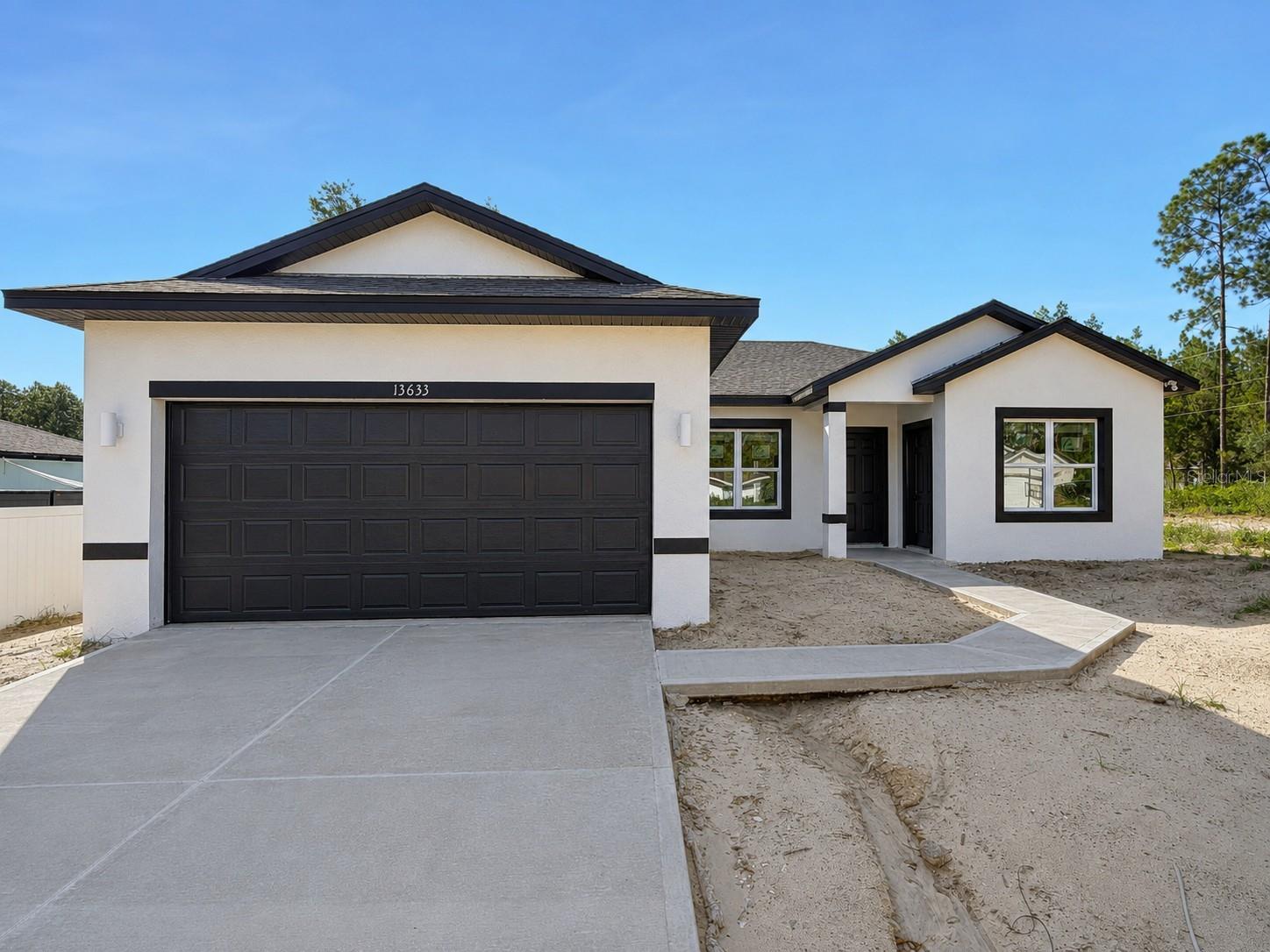 Under Construction. 0.29 ACRES CORNER LOT. BRAND NEW 2026 HOME WITH IN-LAW WITH PRIVATE ENTRANCE IN MARION OAKS! This stunning newly constructed home combines modern living with great income potential, featuring a separate in-law suite with 1 bedroom, 1 bathroom, a kitchen and WASHER AND DRYER, perfect for extended family or additional rental opportunities. The open-concept layout is filled with natural light and luxury vinyl flooring throughout, creating a warm and welcoming space. The spacious primary bedroom includes a master bathroom with DUAL SHOWER, dual sink, offering both comfort and convenience. A SMART KEY entry system adds an extra level of security and ease of access. With a builder’s warranty included for added peace of mind, this property is ideal for families seeking flexibility or investors looking for a promising opportunity.