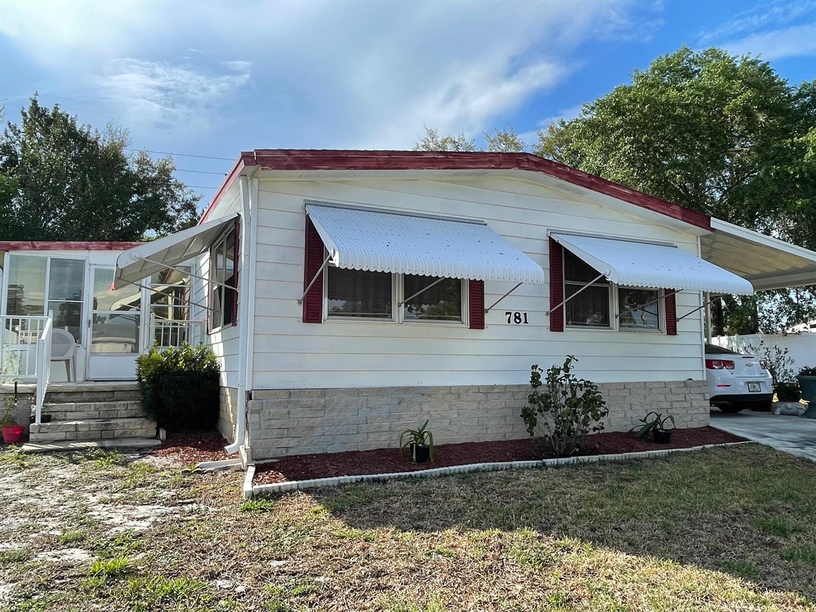 Enjoy Florida living from this desirable 55+ HUD approved community.  This lovely 2 br/2 bath home is centrally located to everything--shopping, dining, the beach and has spacious entertaining areas to enjoy friends and family.  It also has an enclosed porch for added space, a full-length carport plus a storage area.  The $25 yearly association fee is voluntary. ;Water: City