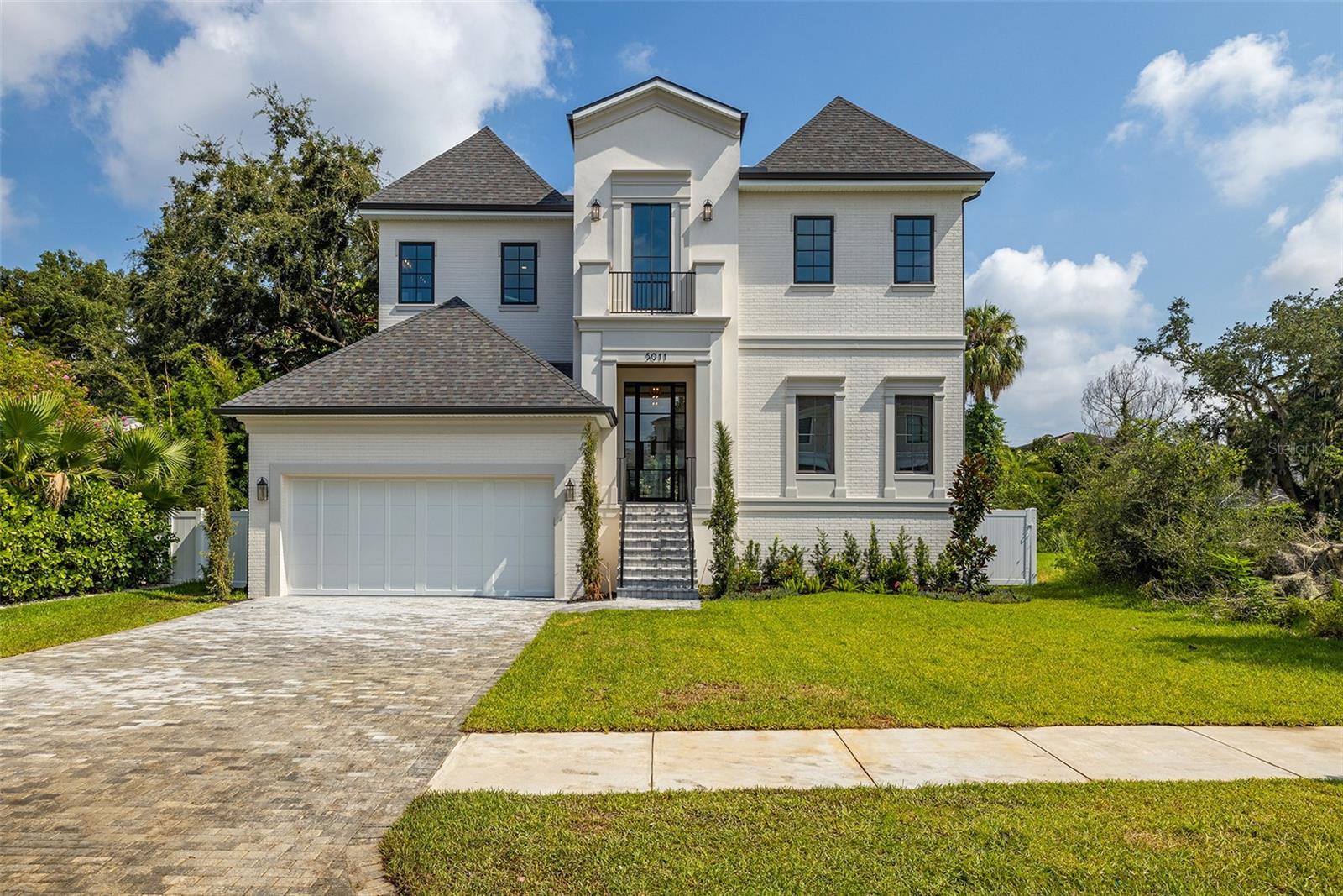 Welcome to your dream home in the heart of South Tampa! This stunning two-story new construction offers luxurious living with modern elegance and thoughtful design throughout. Boasting 5 spacious bedrooms, 5 full bathrooms, and 1 half baths, this home is perfect for families and entertaining.

Step inside through the grand foyer, where you'll be greeted by an open and airy floor plan. The first floor features a versatile guest suite, a convenient mudroom, and a tech room, perfect for working from home. The expansive great room seamlessly connects to the gourmet kitchen, which includes a large pantry, state-of-the-art appliances, and plenty of counter space for culinary adventures.

Step outside to your private oasis?an expansive covered lanai overlooks a sparkling pool and outdoor kitchen, ideal for year-round outdoor living and entertaining.

Upstairs, the master suite is a true retreat, featuring two generous walk-in closets and a luxurious ensuite bath with all the amenities you could desire. Three additional bedrooms, each with their own walk-in closets and ensuite baths, provide comfort and privacy for family and guests. A spacious loft and a convenient laundry room complete the second floor.

The home also includes a 2-car garage, providing ample storage and convenience. Located in the highly sought-after South Tampa area, this home offers proximity to top-rated schools, shopping, dining, and the beautiful Tampa Bay.