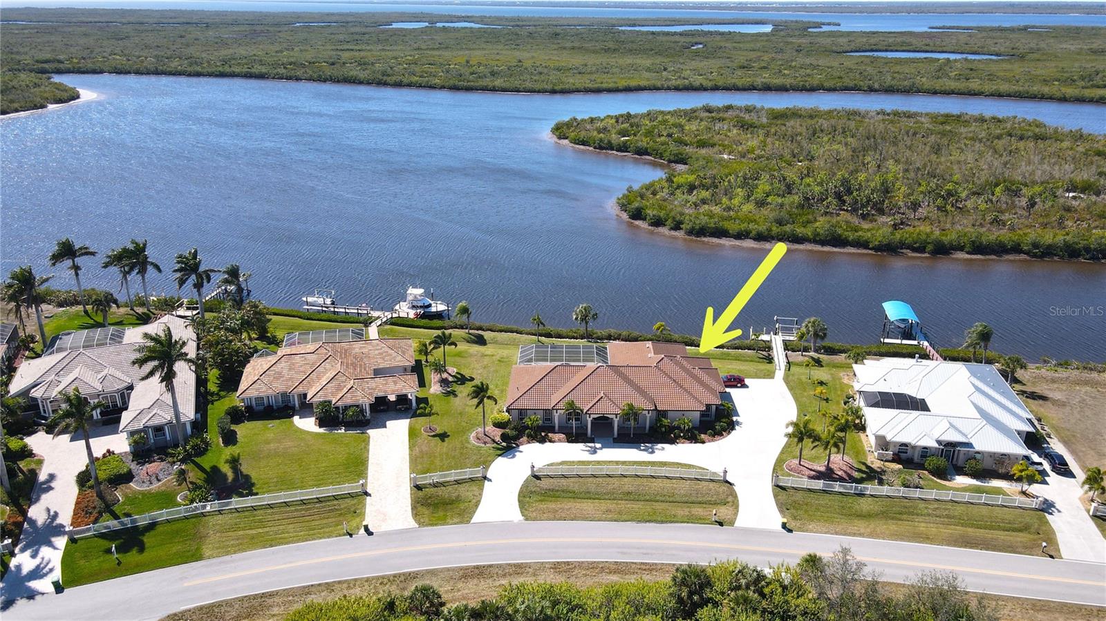 **PLEASE ENJOY THE 3D INTERACTIVE VIRTUAL TOUR ASSOCIATED WITH THIS FABULOUS PROPERTY – Welcome to South Bayview Estates — where luxury waterfront living meets unforgettable sunsets! Perfectly positioned on a rare double lot, this exceptional sailboat-water residence offers approximately 3,585 square feet of air-conditioned living space. Thoughtfully designed for both everyday comfort and effortless entertaining, this home features four spacious bedrooms, a private office/den, four full baths, a tasteful blend of ceramic tile and luxury vinyl plank flooring throughout and a highly sought-after three-car attached garage. Inside, the home has been thoughtfully updated with quality finishes and modern conveniences, including Granite countertops throughout, soft-close cabinetry, LED lighting, stainless steel appliances, double ovens, built-in wine rack and large center island with sink. A 2023 tile roof, along with recently updated A/C and hot water heater adds valuable peace of mind. The expansive Primary Suite serves as a true sanctuary overlooking the pool and features tray ceilings, a comfortable sitting area and dual walk-in closets. Elegant leaded-glass double doors open to the luxurious Primary Bath, complete with separate vanities, a walk-through shower, private water closet, linen closet and additional seating space. This home also offers a spacious den/office... ideal for a gym, studio or flex space and seamlessly connects the Primary Suite to the main living areas. The split-bedroom floor plan ensures privacy for family and guests alike offering a front guest suite with en-suite bath and walk-in shower, two additional bedrooms sharing a Jack-and-Jill bath with shower/tub combination and a third full guest bath with walk-in shower and direct lanai/pool access. All four bathrooms are beautifully appointed with granite countertops, wood vanities and comfort-height toilets. Next, step outside into your private tropical waterfront retreat! The heated saltwater pool and spa (powered by both electric and gas) showcases a cascading waterfall and enjoys prized southwestern exposure, delivering breathtaking sunset views year-round. The expansive covered lanai is built for entertaining, complete with a fully equipped outdoor kitchen. Boating enthusiasts will appreciate the private dock with water and electric service, along with a 9,000-pound boat lift providing quick, unobstructed sailboat access to open water. The extended circular driveway enhances curb appeal and leads to the oversized three-car garage, featuring an epoxy-coated floor, built-in cabinetry and shelving, workbench and bicycle racks — perfectly suited for an active Florida lifestyle. For added convenience and efficiency, the property is also equipped with a 100-pound buried propane tank, currently leased by the owner. This underground system offers a clean, streamlined appearance with no visible above-ground equipment to disrupt the landscaping or curb appeal. Move-in ready and designed for spectacular sunsets, boating adventures and waterfront entertaining, this exceptional property is just minutes from the charm, dining and scenic waterfront parks of Downtown Punta Gorda and Gulf Beaches. Be sure to explore the 3D virtual tour and schedule your private showing today — your waterfront lifestyle awaits!