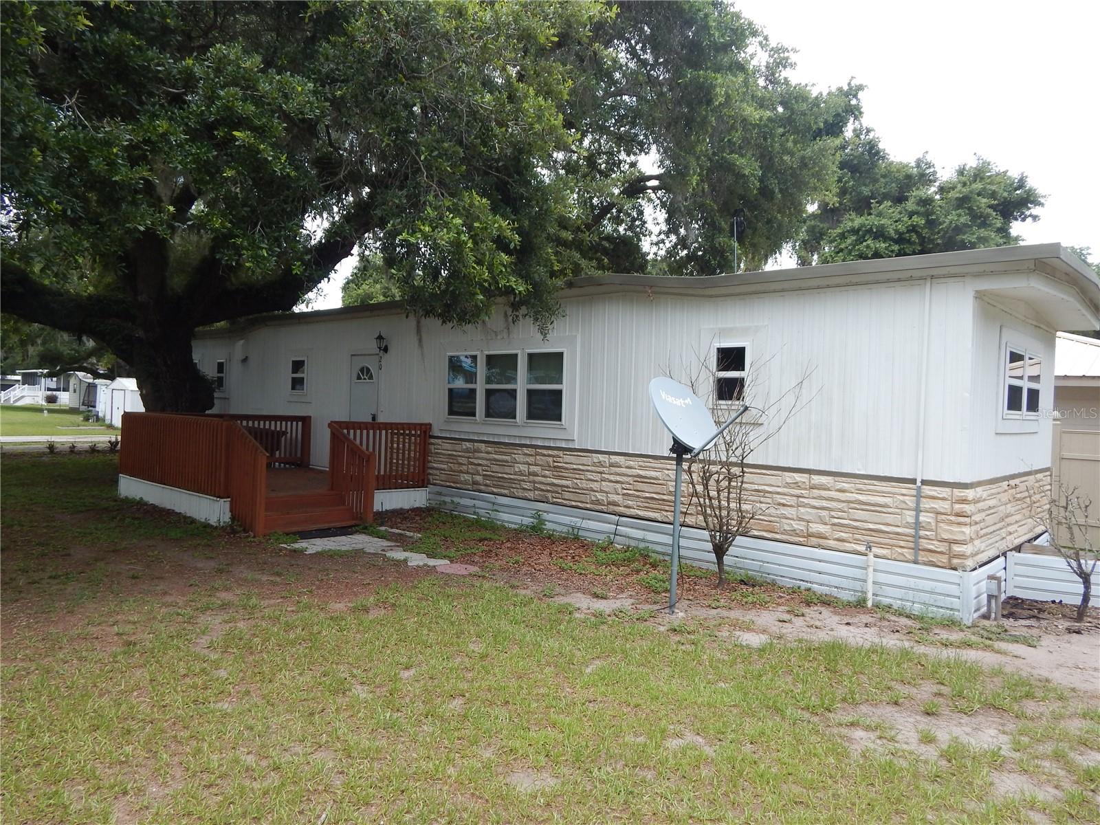 Quaint little Fishing Community with water access at Camp Lester Bait Store and Camp Mack being only a few minutes away from Kissimmee Chain of Lakes.  This single wide mobile home has two bedrooms, two bathrooms and a generous living/dining space. Very quiet atmosphere with great oak trees.  Between either of Florida's beautiful coasts.  Convenient to shopping, restaurants and medical on State Road 60, less than 20 minutes away.  Call today!