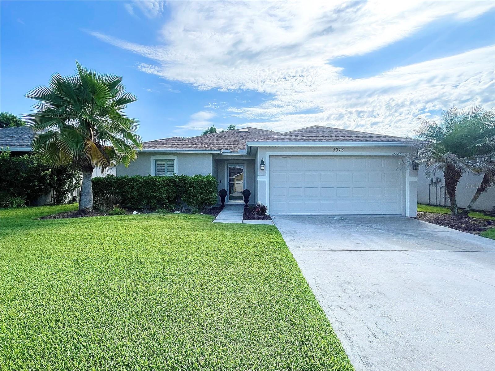 Welcome to 5313 Cordgrass Bend Lane, a beautifully updated 3-bedroom, 2-bath home in Port Orange’s desirable Coquina Cove community. This light-filled residence features an open floor plan, durable wood-look flooring throughout, plantation shutters, modern lighting and ceiling fans, and no carpet. The spacious kitchen offers generous cabinetry, ample counter space, a breakfast bar, black appliances, and a stylish tile backsplash. The primary suite includes a walk-in closet and private bath with a walk-in shower, while the second bathroom offers a tub-and-shower combination. Sliding glass doors open to an expansive paver patio and fenced backyard overlooking the pond—an ideal setting for relaxing or entertaining. Additional features include interior laundry hookups and a two-car garage. Lawn care and HOA fees are included in the monthly rent