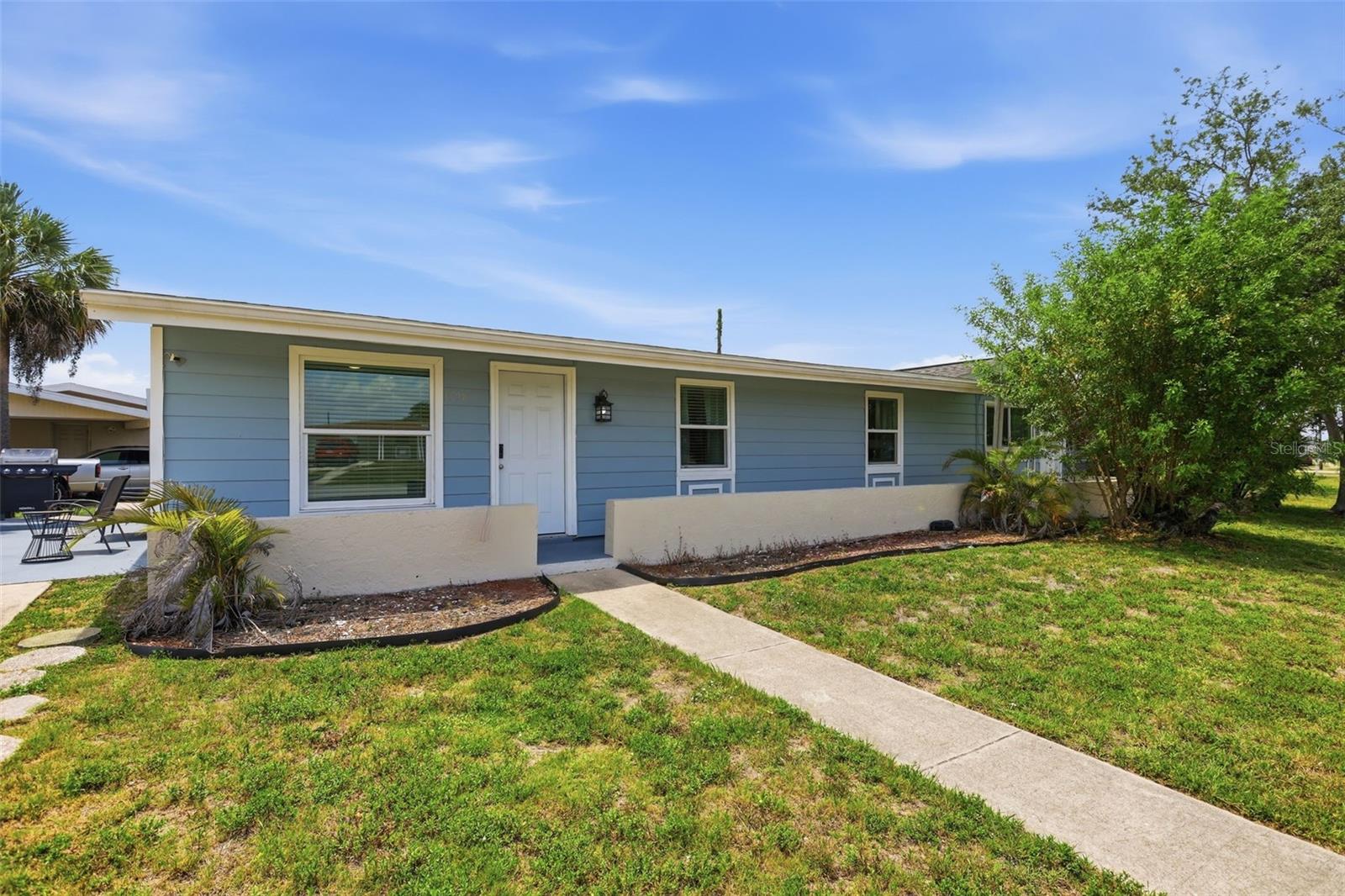 Short Sale. Spacious 4-bedroom, 3-bath home featuring a screened lanai, carport, laundry room, and private pool! This unique property offers flexible living arrangements, including a mother-in-law suite with a separate entrance and kitchenette. The layout could easily function as a 3-bedroom, 2-bath main residence with a separate 1-bedroom, 1-bath efficiency or guest quarters. Recent updates include fresh interior paint, new flooring, a brand-new pool liner, and the home was replumbed in 2021. The property is connected to public sewer service—newer windows and doors. Situated on a large corner lot, this home is conveniently located near both an elementary and a junior high school.  Seller will entertain all reasonable offers. No warranties, expressed or implied, are provided by the seller or listing agent.