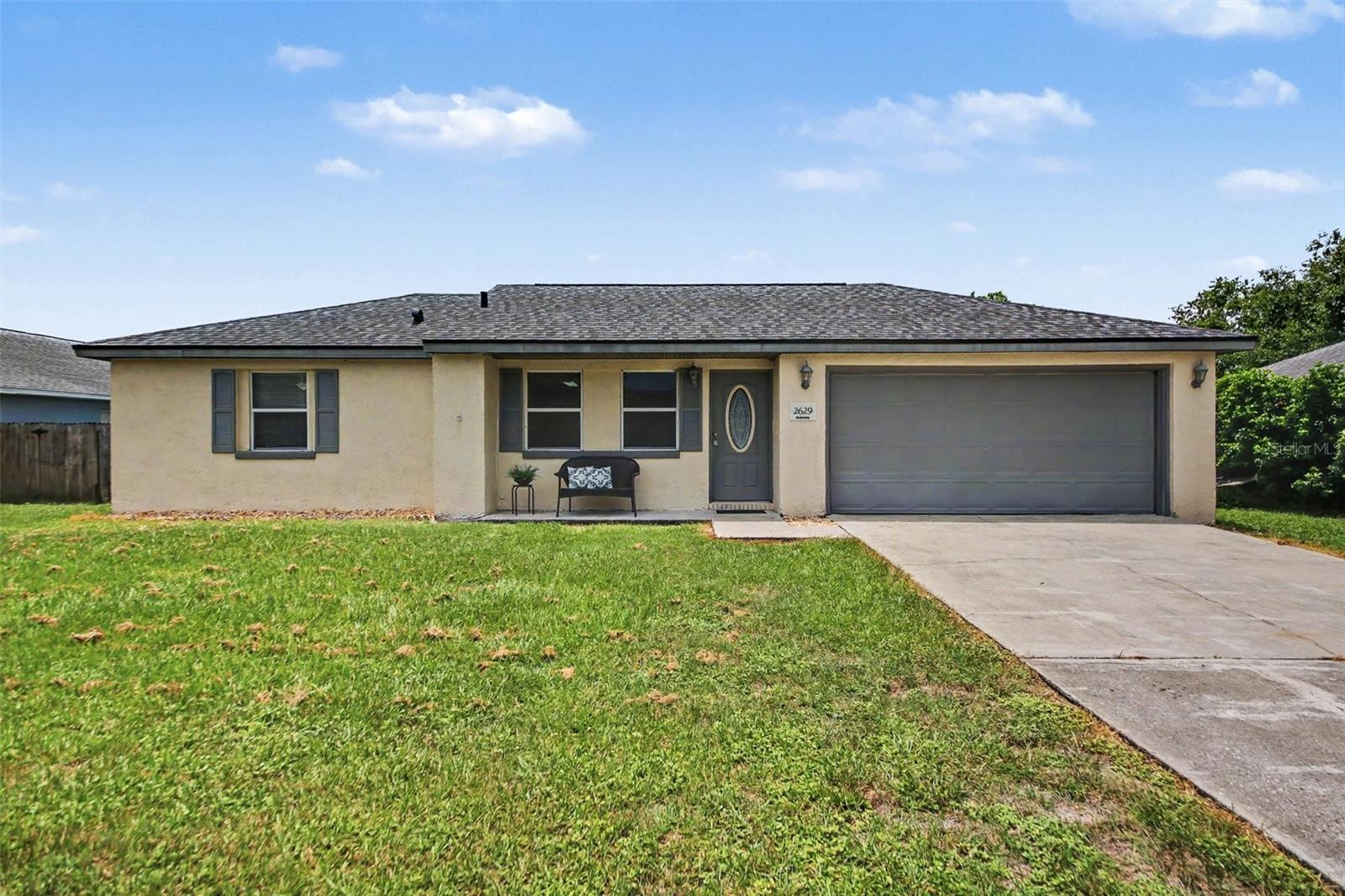 One or more images are Virtually Staged* Move-in ready Deltona home with no HOA, a BRAND NEW Roof (June 2026), updated kitchen and bathrooms, and a large fenced backyard! This super cute, well-maintained home offers the features buyers are looking for, including dual-pane energy-efficient windows, ceramic tile and laminate flooring throughout (no carpet anywhere!), vaulted ceilings with knockdown texture, and a screened patio. The popular split-bedroom floor plan provides privacy and flexibility, and peace of mind with both cosmetic and mechanical upgrades.

The updated kitchen is both stylish and functional, featuring shaker-style cabinets, granite countertops, stainless steel appliances, and a layout that connects easily to the dining and living spaces, making everyday living and entertaining simple. Both bathrooms have also been updated, giving the home a fresh, move-in ready feel without the need for major renovations.

Outdoor living is a standout feature, with a spacious screened patio overlooking an oversized fenced yard, perfect for pets, play, gardening, relaxing, or weekend gatherings. The 2-car garage offers additional storage, giving buyers room for tools, bikes, holiday décor, and everyday essentials. The water heater was installed in 2010, and the AC (2005) has been regularly serviced.

Located in Deltona, FL, this home offers an excellent opportunity for buyers looking for value, space, privacy, and convenience without HOA restrictions. With major updates already completed, a flexible layout, low-maintenance flooring, energy-efficient windows, and a large outdoor space, this home is priced to sell and ready for its next owner!