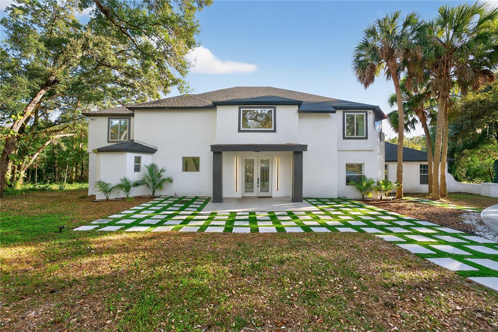 Welcome home to this stunning, fully renovated home sitting on 1.51 acres in the coveted Sweetwater Club neighborhood. The home has been professionally remodeled from top to bottom with marble tile flooring and walls throughout most of the first floor. Pull into the lot by way of the wrap around driveway that leads to a massive three car garage, with extra exterior parking space as well. Upon entry, you'll be greeted by a gorgeous luxury vinyl plank staircase with a luxury glass railing. To your left is the show-stopping kitchen with brushed-gold accents throughout, and new high-end appliances to match. You'll be amazed by the honeycomb-inspired mosaic backsplash and the gorgeous premium light fixtures above the island and in the attached dining room. The kitchen also features a massive walk-in pantry, a smaller bonus pantry, a convenient half bath, and a hidden protracting charging station for all of your wireless needs. From the dining room, step down into the family room with a gorgeous built in electric fireplace that also connects to the expansive living room, both with massive ceiling fans. Also conveniently located on the first floor is a bonus room with an exterior door that's perfect for an office. From there, step into the massive 3 car garage that has also been finished with marble tile flooring. Connected to the garage is the 5th bedroom with exterior access and a full ensuite bathroom, perfect to convert to an in-law suite, or even a gym or tool room. From the living room, step out to the back patio area that is made for entertaining. It has been set up with a bar, wine cooler, built in grill, and a large fan to create the perfect space that is just begging to watch your favorite sports team with friends and family. Then of course is the pool and built in hot tub, a convenient half bath, and also includes a sauna that comfortably accommodates three guests. Upstairs you'll find the four main bedrooms, with two of the guest rooms having full ensuite baths with exterior access to the upstairs patio overlooking the pond. The laundry room is conveniently located upstairs as well, so no worrying about running back and forth downstairs for your laundry duties. The primary bedroom is massive, and includes a built in vanity desk with custom shelving, additional built in shelving, a massive walk in closet, and exterior access to a covered outdoor hallway that connects to the second bedroom. The primary bathroom is truly show-stopping with a massive frameless shower, floating custom vanities, brushed gold hardware, and an architectural wood-slat feature wall creating a true resort-style ambiance. 

EVERY major system (roof, HVAC, electrical, and plumbing) has been updated and is less than two years old, and the home also features a tankless hot water heater. The septic tank was also cleaned/inspected in September of 2025. Every window and sliding door has been upgraded to double-pane, giving you energy efficient peace of mind that is a must-have in the Florida heat. With designer finishes throughout, luxurious living spaces, and attention to detail from top to bottom, the only thing missing is you! Schedule your private showing today before someone else calls it home.