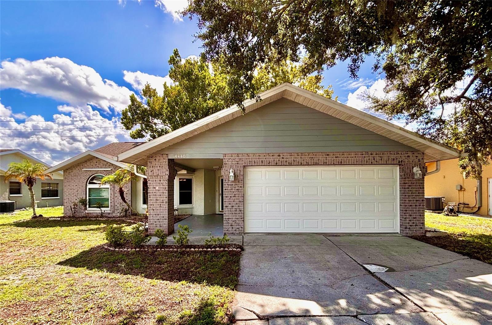 Located in the community of Wood Trail Village, this 3-bedroom, 2-bathroom, 2-car garage home offers 1,606 square feet of comfortable living space with a functional layout and plenty of potential. Inside, you'll find a spacious living room, a split-bedroom floor plan, and a large open kitchen overlooking the family room, creating a central gathering space for everyday living. The kitchen features Corian countertops, wood cabinetry, and stainless steel appliances. Outside, you'll find the screened-in patio overlooking the backyard, complete with a storage shed for tools and outdoor equipment. Additional updates include a recently replaced garage door, new windows and storm shutters. and a roof installed in 2014. Conveniently located within the sought-after River Ridge Middle and River Ridge High School district, this home is approximately 15 minutes from the Suncoast Parkway, 10 minutes from US Highway 19, and just minutes from hospitals, restaurants, shopping, and everyday conveniences. If you're looking for a well-built home in a desirable neighborhood where you can add your own personal touches over time, this Wood Trail Village property is well worth a look. The seller is offering a $2,500 credit toward a driveway repair where the tree root damaged and lifted a portion.