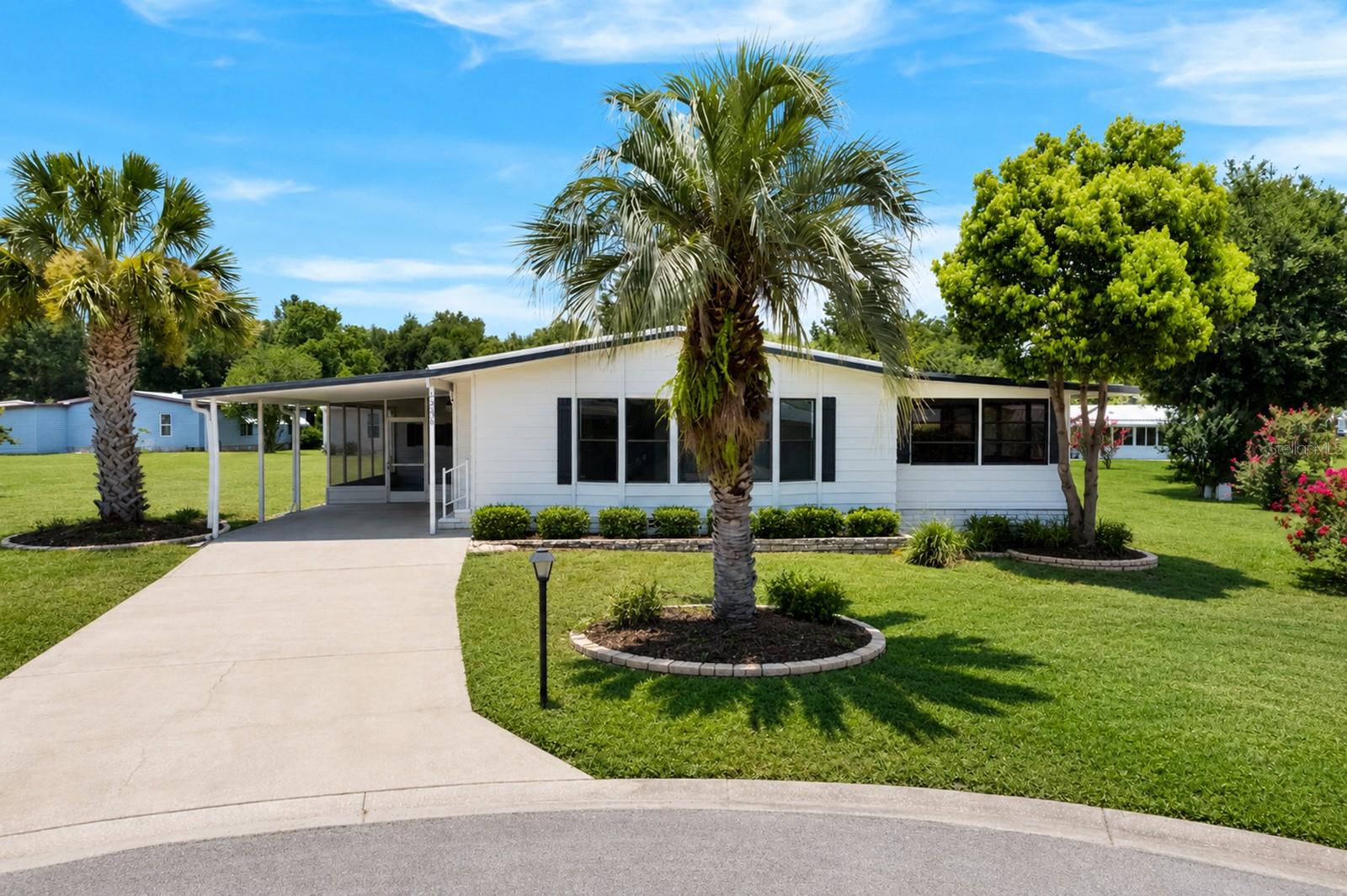 Experience affordable, carefree living in one of Florida's premier gated golf course communities. Residents enjoy exceptional amenities, including an on-site restaurant and a full calendar of planned activities and social events.
Located in the highly desirable pet-friendly, this well-maintained home sits on a quiet cul-de-sac just a short distance from the community post office. The spacious kitchen features a large center island, a built-in desk area, and an oversized pantry—perfect for everyday living and entertaining. With more than 1,500 square feet of living space, the home offers generously sized bedrooms and a comfortable, open layout. The beautifully landscaped lot provides mature trees, added privacy, and a peaceful setting to relax and enjoy Florida living. HOA provides: Basic lawn care and edging, internet / cable, waste pick up 2 times weekly, yard pick up 1 time week. Gated community .