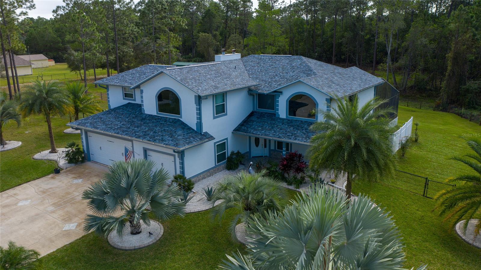 AMAZING 5 ACRE ESTATE W POOL! This gorgeous 3/3 2 story home sits on 5 acres (2-2.5 deeded separately) just 15 minutes from downtown New Smyrna Bch or Port Orange! The 1st floor bonus room could be used as an extra bedroom just add an armoire! It boasts high ceilings, new upgraded double pane windows, saltwater sparking pool, open floor plan with updated kitchen w granite countertops, new roof with skylights, new paint interior and exterior, new flooring, LED lighting throughout, new well and 85 ga tank, new water softener, new salt generator and heater for pool, new barn, new fencing, 3 car garage, in fact so many new and upgraded features we can't list them all! You need to take a tour and see for yourself! Bring your horses, goats or other animals! CALL TODAY AND SCHEDULE YOUR PRIVATE TOUR!!