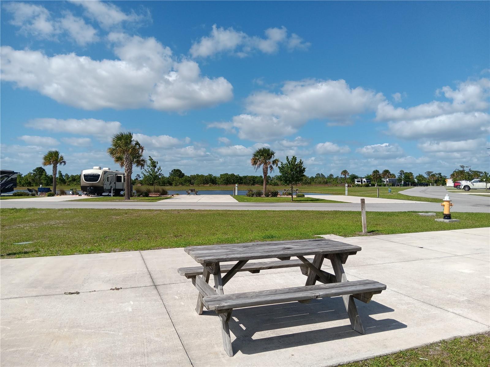 Welcome to the Resort at Canopy Oaks, a premier luxury RV community in Central Florida where elevated lifestyle meets exceptional value. This deeded, corner, RV lot presents a rare opportunity to own within one of the area’s most sought-after resort-style destinations, ideal for personal enjoyment, seasonal living, or investment potential. Ideally located on a corner lot with two ponds visible, this lot provides more space and pleasant views!

Spanning approximately 435 acres, Canopy Oaks offers a true resort experience with a beautifully appointed clubhouse, pool and spa, tiki bar, pickleball courts, fitness center, café, and a vibrant calendar of social activities. Owners also have the option to participate in the on-site rental management program, creating an effortless path to income when not in use. The lot is currently successful on the rental program.

This lot features a concrete pad with full utility hookups and the opportunity to enhance and personalize the space with approved upgrades such as pavers, landscaping, or outdoor living areas—allowing you to create your own private Florida retreat.

Positioned within a growing and highly desirable community, this property stands out as a compelling opportunity for buyers seeking both lifestyle and long-term potential. Whether you're looking to relax, invest, or enjoy the best of RV resort living, this is your chance to secure a place in Canopy Oaks. Schedule your showing today. The sellers also have an RV lot for sale at Champions Run Luxury RV Resort in Ocala. Buy both and divide your time between the two resorts for the ultimate RV lifestyle!