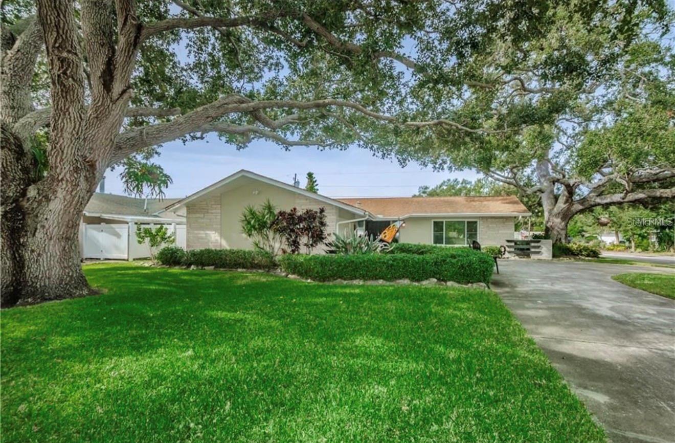 Welcome to this beautifully maintained 3-bedroom, 2-bathroom home offering 1,890 square feet of living space on a spacious corner lot in the heart of Largo! This move-in-ready residence features a desirable split-bedroom floor plan, updated kitchen with granite countertops, stainless steel appliances, abundant cabinetry, Large  bathrooms, and an inviting covered patio  perfect for entertaining. Additional highlights include newer flooring, an inside laundry room with built-in office space, a circular driveway, attached garage, fenced backyard, and mature landscaping. Situated in a non-flood zone, this home offers peace of mind and the perfect blend of comfort and convenience. Ideally located just minutes from the pristine Gulf beaches, including IndianRocks Beach, residents can enjoy boating, fishing, waterfront dining, and breathtaking sunsets year-round. Outdoor enthusiasts will appreciate the nearby Florida Botanical Gardens, George C. McGough Nature Park, John R. Bonner Nature Park, and the Pinellas Trail for walking, biking, and recreation. Conveniently close to shopping, dining, marinas, golf courses, and top-rated local amenities, this home truly captures the best of the Florida lifestyle. Whether you’re looking for a primary residence, vacation getaway, or investment opportunity, this exceptional property is a must-see!
