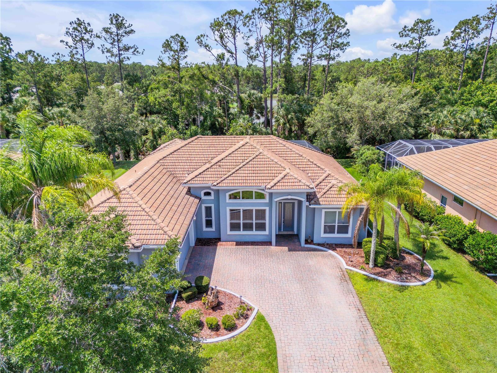 Tucked away on a quiet cul-de-sac in the sought-after gated community of Venetian Bay, this 4-bedroom, 3-bath pool home and office offers the perfect blend of privacy, comfort, and Florida living. Set on a beautifully landscaped waterfront lot overlooking a serene canal and natural wooded backdrop, this property provides peaceful views with no rear neighbors in sight.

Inside, you'll find over 2,500 square feet of living space highlighted by soaring ceilings, an open-concept layout, abundant natural light, and expansive living and dining areas designed for both everyday living and entertaining. The spacious kitchen features granite countertops, ample cabinetry, a breakfast bar, and seamless flow into the main gathering spaces.

The primary suite serves as a private retreat with a large walk-in closet featuring custom built-ins and a spacious en-suite bath complete with dual vanities, a garden tub, and separate shower. Additional guest bedrooms provide flexibility for family, visitors, or a home office.

Step outside to your own backyard oasis where a screened-in pool and covered lanai overlook tranquil water and preserve views. The outdoor kitchen makes entertaining effortless while the expansive pool deck offers plenty of room for relaxing and enjoying the Florida sunshine year-round.

Located within Venetian Bay, residents enjoy access to parks, pickleball courts, golf, golf-cart-friendly streets, walking trails, dining, and shopping, all while being just minutes from New Smyrna Beach's beautiful coastline, local restaurants, and major conveniences.

Whether you're searching for a full-time residence or a Florida retreat, this exceptional home delivers space, privacy, and resort-style living in one of New Smyrna Beach's most desirable communities.