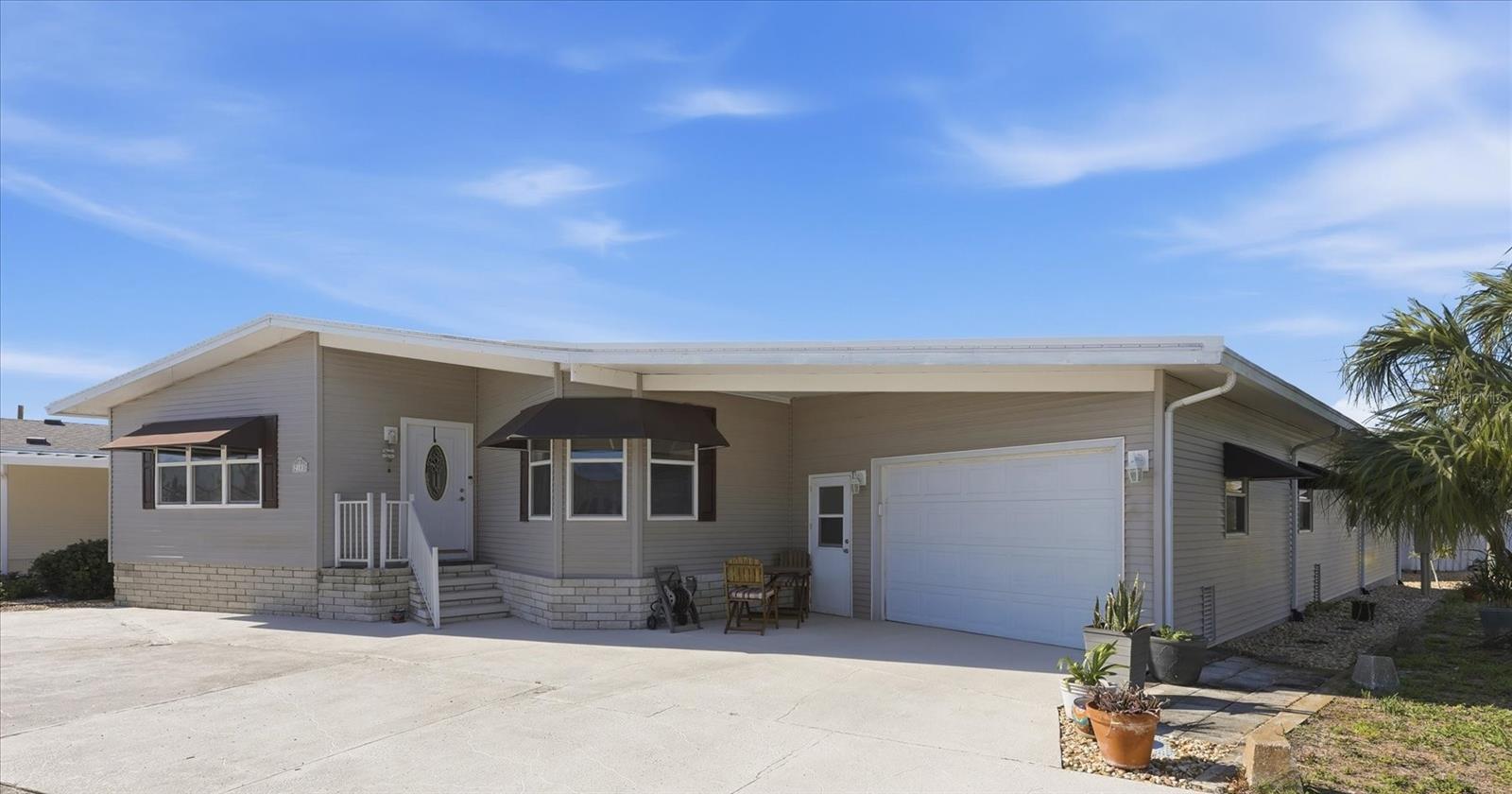 MODERN COMFORT MEETS COASTAL LIVING in this beautifully maintained 3 Bedroom, 2 Bath Palm Harbor Manufactured Home with attached Garage on a Lot and a Half in the highly desired, active 55+ Trailer Estates community. Light and airy Florida Room to enjoy your morning coffee and a good book. Gorgeous, gleaming hardwood floors throughout Living, Dining, Florida rooms and hallway. Large Primary Bedroom with wall-to-wall closet and en-suite bath. Huge versatile BONUS space just off the garage is currently staged as a 3rd bedroom, but delivers flexibility as an entertainer’s dream Game Room, extra living space for a Guest suite, Multi-generational living suite or workshop. Rarely do you find anything like this on the market! Laundry facilities located in the garage, however there are also washer/dryer hookups inside the home. AC 2024, Roof 2017, WDO tented 2024. The garage and an extra shed provide a ton of storage. Most of the furniture conveys. Live where everyone wants to be! You own the land. Boaters have direct access to Sarasota Bay from the Marina. Enjoy the large heated community pool, hot tub, gym and wood shop. The community buzzes with pickleball, shuffleboard, kayaking, horseshoes, bocce, dancing and more. A US Post Office on site. 10 minutes to Sarasota-Bradenton Int’l Airport. Convenient to shopping, restaurants, the Arts and everything in Bradenton/Sarasota.