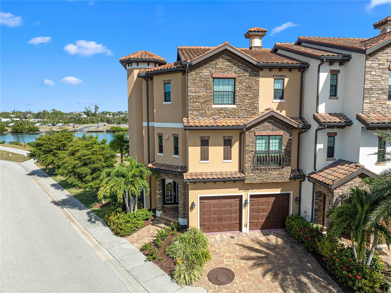 NEW AND IMPROVED PRICE! Experience elevated coastal living (X FLOOD ZONE) in this custom MPS-built luxury residence, completed in 2019 on one of Venice Island’s premier homesites along the scenic Venetian Waterway Trail. PLEASE NOTE: There is NO COMMON WALL shared, unit is separate. Here, timeless craftsmanship meets intentional engineering, surrounded by private landscaping, Intracoastal Waterway views, and effortless walkability to beaches, boutiques, cafés, and Venice’s charming downtown. Inside, every detail reflects artistry and precision. Crown molding in every room, refined lighting selections, and custom ceiling treatments highlight the home’s flawless finish quality. Imported Italian porcelain tile and rich textures complement the expansive linear quartz fireplace, creating a stunning focal point that blends warmth and modern design. Premium tile flooring, installed with precision, enhances the home’s serene coastal palette and natural flow. A private elevator, equipped with a dedicated landline phone, provides effortless access to all three levels—a thoughtful convenience paired with the architectural beauty of solid wood staircases that ground the home with warmth and craftsmanship. Engineered for comfort and quiet efficiency, this residence features whole-house expanding spray foam insulation, individually zoned Mitsubishi climate control with separate air handlers on each floor, a fire suppression system, hurricane-impact windows and doors, and a whole-home instant hot water system—delivering peace of mind and modern performance. The outdoor living spaces are equally intentional. The custom Walpole Outdoors pergola, crafted from solid-cell PVC AZEK with an aluminum core, is both beautifully designed and completely maintenance-free—a rare balance of art and function. Cypress ceilings enrich both the front porch and lanais, adding depth and timeless character to each outdoor space. The back lanai, framed by a decorative wrought-iron fence and privacy landscaping, offers a tranquil retreat for morning coffee or golden-hour sunsets. From here, enjoy layered views of the Intracoastal Waterway, the Venice Train Museum, and the peaceful Venetian Waterway Trail—an authentic glimpse into the rhythm of Venice Island living. Even the garage is elevated with a Gorilla Garage floor coating, offering a sleek, designer-grade finish 20x stronger than epoxy, combining durability with high-end design. From the cypress-paneled lanais to the artisan-crafted interior finishes, every element of this home is intentional, curated, and timeless—delivering the refined coastal lifestyle buyers dream of. Beyond the home itself, Venice Island living offers a lifestyle unlike any other. Walk the Waterway Trail at sunrise. Bike to the beach in minutes. Stroll to boutique shops, al fresco dining, or enjoy live music, the Venice Theatre, and seasonal festivals beneath palm-lined streets. From the weekly farmers market to emerald-green golf courses and waterfront parks, every day here is a celebration of connection, comfort, and coastal sophistication. This is more than a residence—it’s an invitation to live beautifully, where craftsmanship meets calm and the timeless charm of Venice Island becomes part of your everyday story. ¤ Please see 3D Tour and Video ¤