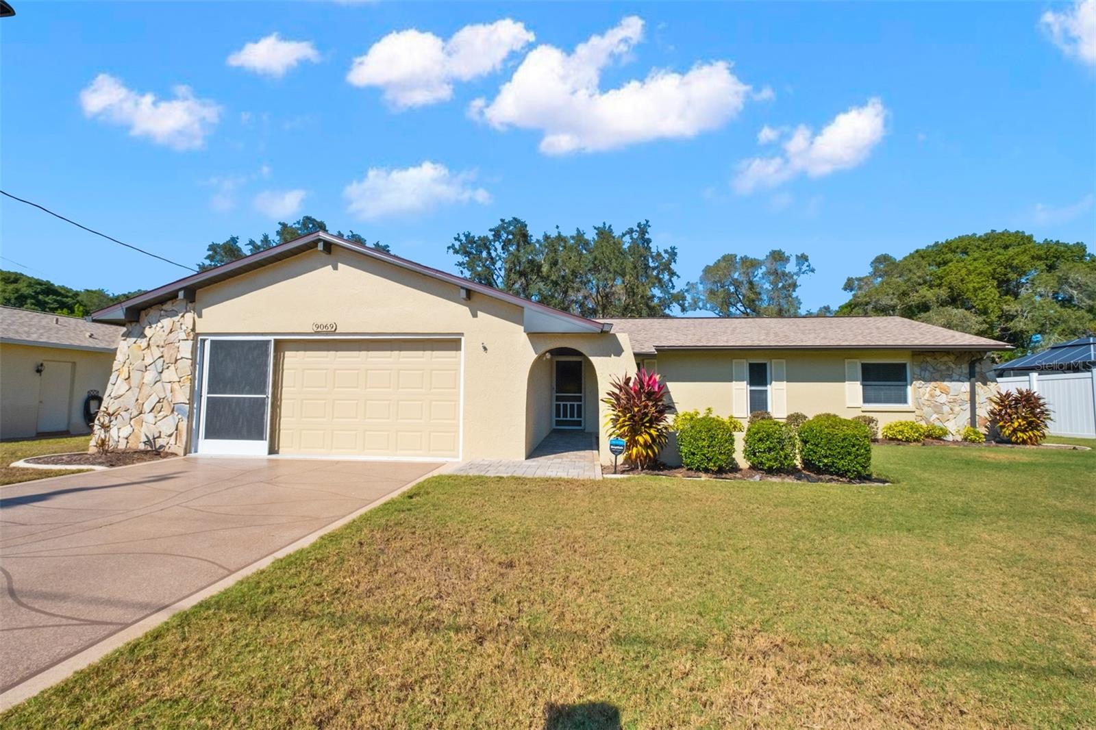 Welcome to this delightful pool home offering two-bedroom, two-bathroom which can easily be converted into a three-bedroom layout.  As you approach, you will notice its beautiful landscape, freshly painted exterior, new gutters and soffits, new roof (4/2022) brick paver entry way, new double-pane vinyl windows throughout along with a new garage door and screen slider creating an inviting first impression. Inside, the home is not only aesthetically pleasing but also highly versatile. Currently configured with two bedrooms, there's potential for conversion into a three-bedroom layout, providing adaptability to suit your needs. The spacious living areas are adorned with natural light, creating a warm and welcoming atmosphere. One of the standout features of this home is the inviting pool, offering a perfect retreat for relaxation or outdoor gatherings. The pool area is a private oasis, surrounded by the well-maintained landscape, providing a serene backdrop for your leisure moments. A two-car garage adds convenience, offering not just parking space but also additional storage possibilities. The exterior upgrades extend to the functional aspects of the home, ensuring both style and substance. Step into the kitchen, where a suite of new Whirlpool appliances awaits, elevating the cooking experience and adding a touch of modernity to the heart of the home. Whether you're a culinary enthusiast or just appreciate the convenience of top-notch appliances, this kitchen is sure to impress. This home is conveniently located near shopping, restaurants, and entertainment. It is also close to major highways and the Suncoast Parkway for easy access to Tampa and the surrounding areas. This home is a great opportunity for anyone looking for a move-in ready home in a great location. With its updated features, large backyard, and potential for a third bedroom, this home is sure to please. Don't miss out on this great opportunity!