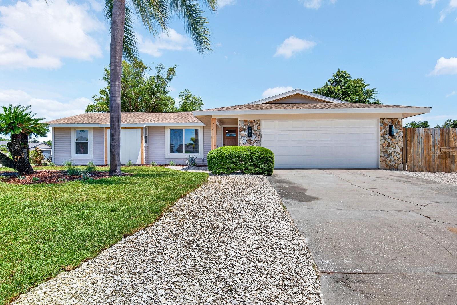 Virtually Staged. Welcome to this thoughtfully designed coastal renovation in a highly desirable West Bradenton location! Just minutes from Bradenton Beach, Anna Maria Island, IMG Academy, GT Bray Park, shopping, dining, and everyday conveniences, this beautifully updated home offers the perfect blend of modern style, flexibility, and relaxed Florida living with NO HOA and NO deed restrictions.

Situated on a spacious corner lot, the property offers exceptional versatility with ample side parking ideal for a boat, RV, trailer, golf cart, or additional vehicles. Fresh sod with irrigation in the front, side, and backyard enhances the curb appeal while creating inviting outdoor spaces designed for entertaining, relaxing, and enjoying the coastal lifestyle.

Inside, the bright open-concept layout feels airy and welcoming from the moment you enter. Luxury vinyl plank flooring flows throughout the home, complemented by fresh finishes and thoughtfully curated designer details. The stunning kitchen serves as the centerpiece of the home, featuring an oversized navy island with double-sided cabinetry, quartz countertops, shaker-style cabinets, stainless steel appliances, subway tile backsplash, and abundant prep and storage space. A spacious walk-in pantry with custom wood shelving adds both style and functionality.

The flexible floor plan includes 3 bedrooms plus a versatile flex space with a modern frosted-glass sliding door, perfect for a home office, media room, gym, hobby room, or additional living space. Both bathrooms have been beautifully updated with modern coastal finishes and designer tile selections, while warm cedar architectural accents and the wood-look front entry door create a custom upscale feel throughout the property.

Recent major updates include a NEW ROOF installed in 2026 and HVAC system installed in 2024, offering added peace of mind. The exterior features freshly painted trim, updated lighting, shell walkways, modern landscaping, and cedar-wrapped accents that create standout curb appeal and a welcoming first impression.

The oversized lot provides outstanding flexibility for outdoor living, recreational storage, and future possibilities, all while being conveniently located close to Gulf beaches, parks, boating, restaurants, and entertainment. Located in Flood Zone X, this move-in-ready home combines coastal-inspired design, modern updates, functional outdoor space, and an unbeatable West Bradenton location to capture the very best of the Florida lifestyle.
