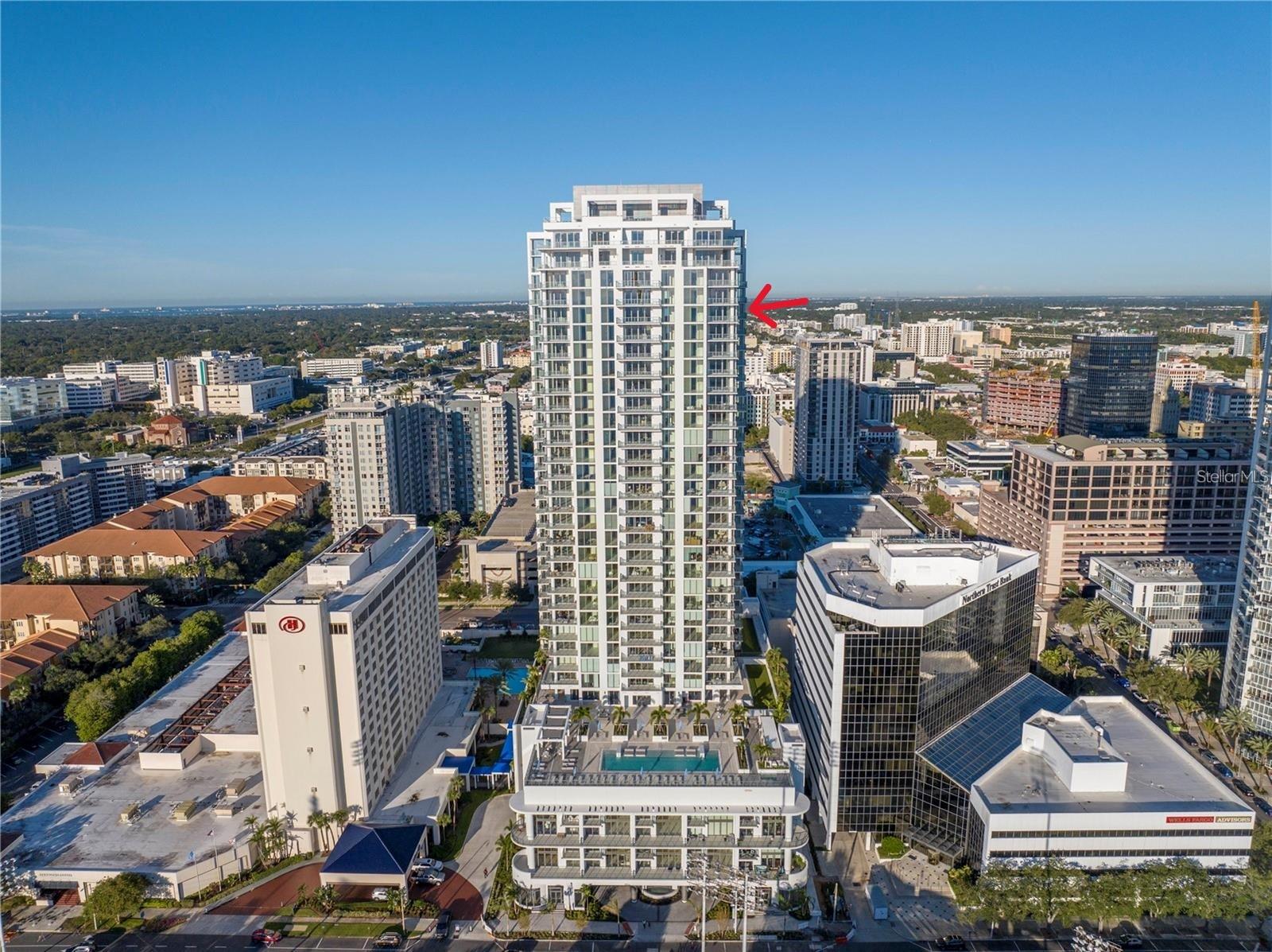 This 3 bedroom, 4 full bath, 2712 SF Azure unit at Saltaire features custom and luxurious upgrades with floor to ceiling, unobstructed views from the NE corner of St. Petersburg's premier luxury condo building. Step into a bright entry & open living room, with high ceilings, recessed LED lighting, & gorgeous large format porcelain tile floors. Follow the light into the custom chef's kitchen, thoughtfully redesigned by Michael Bright of Bright Wood Works, in coordination w/ Exceptional Granite Tile and Marble. The original island was made wider to accommodate more storage, & is covered with a waterfall edge Pompeii Greylac Book Match quartz that effortlessly transitions to the adjacent countertops & backsplash. A Jenn-Air fridge was custom outfitted to blend in with the cabinetry, & top of the line Miele cook top, microwave, oven, dishwasher, & coffee maker are just a few upgrades. Custom details like hidden outlets & charging stations, hydraulic openers on upper cabinetry, specialty trash opener, paper towel dispenser, Franke sink, & more make this kitchen an entertainer's dream! For ultimate entertaining, the kitchen is open to expansive dining space, featuring a custom tray ceiling with changeable LED lighting to highlight the most spectacular of chandeliers. Bright Wood Works also designed a fabulous wet bar, complete with lighted displays, Sub-Zero wine cooler, beverage refrigerator & ice maker, & more hidden storage for all your party supplies. The kitchen, dining room, & family room are one expansive, light filled space with floor to ceiling impact windows, automated roll down shades from the Blind & Shutter Gallery, custom built-in home theater featuring a 78” Sony TV w/ Definitive Technology towers & Denon surround sound, lighted display case, & sliding doors that open to a large outside covered balcony. From your living space & master bedroom, you have spectacular views of Tampa Bay, Albert Whitted Airport, multiple yacht basins, the Pier & Downtown St. Petersburg. Continue through the family room to your master suite, w/ floor to ceiling windows, automated roll down shades, custom crown molding, Artemis lighted ceiling fan, two walk in closets customized by Closets By Design, & a gorgeous master bath re-imagined by Michael Bright. Custom floating double vanity features lighting above & below, w/ extra storage & custom under mount porcelain sinks. Toilet closet features frosted glass enclosure hiding a top of the line Toto toilet, & generous glassed walk in shower features a built in bench & soap niche. The Azure plan features a split bedrooms, so your guests can enjoy private guest rooms off the living room. Two guest bedrooms feature high ceilings, Artemis lighted ceiling fans, walk in closets customized by Closets By Design, & en-suite bathrooms w/ custom vanities, porcelain under mount sinks, Toto toilets, & walk in showers. There is a large laundry room w/ Whirlpool washer & dryer, utility sink, & extra wine cooler. A fourth full bathroom is in the hallway for convenience, w/ Toto toilet & shower that has been converted to a storage closet. This unit also has a deeded storage unit in the common area hallway, & two deeded parking spots together on the 3rd Parking Floor. Saltaire is a fabulous building w/ covered drive in entry, grand lobby with 24 hour concierge, resort style pool and spa, cozy cabanas, social & club rooms, fitness center, dog run, and more. Make your private appointment today!
