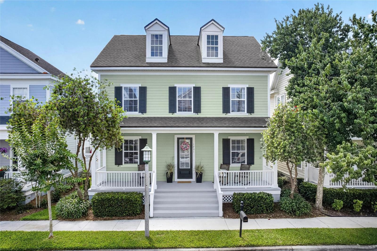 Welcome to 1231 Golden Canna Lane. This beautifully maintained “Charlesworth” floor plan is located in the highly sought-after Aquila Reserve in Celebration’s East Village. Recent improvements include a NEW ROOF (2022) and NEW HVAC SYSTEM (August 2025). Surrounded by scenic conservation views and tranquil water features, this elegant 4-bedroom, 2.5 bath home offers timeless architecture, abundant natural light, and a thoughtfully designed floor plan ideal for both everyday living and entertaining. Neighbors and Friends gather on the charming covered front porch for Celebration's Light & Lemonade and neighborhood get togethers.  The inviting interior features expansive windows, an Open Floorpan allowing for your desired options; currently a living and dining room. A dramatic two-story family room overlooks the private fenced backyard and brick paver patio- a wonderful way to extend your outdoor Living area. The spacious kitchen is designed for gathering and functionality with granite countertops, stainless steel appliances, White 42” cabinetry, center island and breakfast bar seating. The first-floor primary suite provides a peaceful retreat with generous proportions, walk-in closet, and Totally Renovated En-Suite bath featuring dual vanities, and a beautiful, functional tiled walk-in shower with gleaming Glass doors. The second level features three generously sized secondary bedrooms, a full bath and a flexible living space. A detached rear-entry 2-car garage and additional driveway pad for 2 additional vehicles provide flexibility for parking and storage needs. The rear alley access preserves the home’s classic front streetscape and curb appeal while offering functional everyday convenience. Enjoy the close proximity to the East Village pool and playgrounds, Celebration Town Center dining and shopping, miles of walking and biking trails, Orlando International Airport, major highways, and Central Florida attractions. Be sure to use the Virtual Tour link for the immersive 3D walkthrough and floor plan experience!