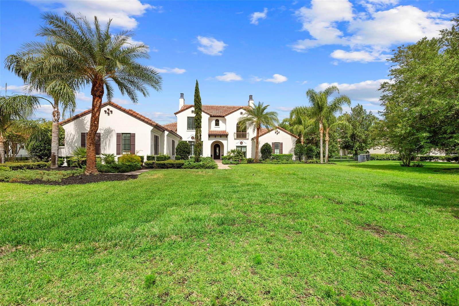 Located within the exclusive guard-gated community of Pablo Creek Reserve in Jacksonville, FL, this well-appointed custom Mediterranean-style estate offers the perfect blend of luxury, functionality, and timeless design. Boasting 5 BEDROOMS, 5.5 BATHROOMS, a 3-CAR GARAGE, and over 4,800 SQFT of elevated living space, this home is designed for both grand entertaining and comfortable everyday living. The heart of the home is the chef’s kitchen, a dream for entertainers and culinary enthusiasts alike. Featuring dual islands, two farmhouse sinks, two dishwashers, TWO HIGH-END REFRIGERATORS, a gas cooktop with custom range hood, wet bar with wine fridge and ice maker, walk-in pantry, and new quartz countertops—this space is thoughtfully crafted for both form and function. The open-concept living area showcases new luxury vinyl plank flooring, a gas fireplace with floating built-ins, and gorgeous views of the pool and tranquil water beyond. Just off the main living area is the moody, design-forward primary suite, completely blacked out for serenity, with oversized drapes, tray ceiling, and an en-suite spa bathroom featuring dual vanities, a steam shower, and an oversized walk-in closet with built-ins and a center island ideal for watches, jewelry, or outfit planning. The first-floor office offers built-in cabinetry, French doors, and a shared view of the impressive saltwater pass-through fish tank. Nearby, you'll find a designer half bath, stylish mudroom cubbies, and a functional laundry space off the hallway leading to the garage. A versatile fifth bedroom on the main floor, currently used as a card room, offers direct access to the expansive covered patio. Outdoors, enjoy travertine tile flooring, built-in speakers, and a full summer kitchen, all overlooking the saltwater pool and spa. A bug-misting repellent system lines the gutters and fence for ultimate outdoor comfort. Upstairs, you'll find a spacious loft, three additional bedrooms—each with its own en-suite bath, and a second laundry room with space for stackable washer/dryer. Featuring a WHOLE HOME GENERAC GENERATOR this property is sure to give you peace of mind in the event of a power outage. This exceptional property is a rare opportunity to own in one of Jacksonville’s most coveted communities, where luxury meets thoughtful design in every detail. Call to schedule your private tour today!