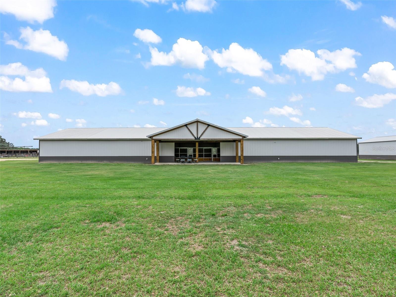 Welcome to a truly exceptional, luxury custom-built equestrian facility designed for both serious horse enthusiasts and those seeking refined country living.

Situated on 16.93 pristine acres, this newly constructed, state-of-the-art facility showcases superior craftsmanship, thoughtful design, and premium materials throughout.

At the heart of the property is an impressive 14-stall barn (144’ x 44’  x 12' | nearly 8,000 sq ft), featuring 14 spacious 12’ x 12’ stalls, each equipped with automatic waterers and swingout feed doors. The barn is meticulously designed for optimal function and comfort, including large overhead fans, a quiet high-powered exhaust system, and multiple roll-up doors for exceptional airflow.


Equestrian amenities are second to none, including a wash rack, feed and tack room with a custom revolving door, laundry room, and a half bath. Above, a finished loft with reinforced flooring and automatic staircase access provides versatile space ideal for storage, an additional office, or viewing area with sweeping views of the barn below.

A stunning office/lounge space offers wood-lined vaulted ceilings, diagonal elongated tile flooring, and expansive windows overlooking the paddocks—creating the perfect blend of productivity and inspiration.


The property is fully equipped for training and care, featuring a hot walker, a 60-foot round pen with 8-foot solid walls, seven paddocks, and one large pasture, all enclosed with new board, no-climb, and electric fencing.



Additional structures include - two hay barns (51’ x 30’ x 12’) on concrete slabs; a shavings barn (18’ x 31’ x 14’); and a storage barn (24’ x 24’ x 10’).

All designed for efficiency, durability, and ease of operation.

The property also includes a 2024-built residential home, offering 2 bedrooms and 1 bath with modern finishes such as beautiful ceramic tile flooring, high ceilings, stone countertops, stainless steel appliances, and a tankless water heater. Both bedrooms feature plenty of space and full closets, the primary with a walk-in closet. The bathroom features a large vanity with lovely square sink, gorgous stone countertops, and stone shower with glass entry! All fixtures and ceiling fans have been upgraded!

For those envisioning expansion, there is a prime home site on the property—perfect for building a larger custom residence.


Additional highlights include - 200 amp electrical service; security camera system, high and dry location in Flood Zone X (no flood insurance required)!

Ideally located just 30 minutes from the World Equestrian Center and 15 minutes to the Florida Horse Park, this property offers convenient access to premier equestrian venues while maintaining peaceful privacy. Nearby shopping, dining, and everyday amenities are all within easy reach.



This is a rare opportunity to own a turnkey equestrian facility—perfect for private use, training operations, or a breeding program—where luxury meets functionality in every detail. Schedule your private tour now.