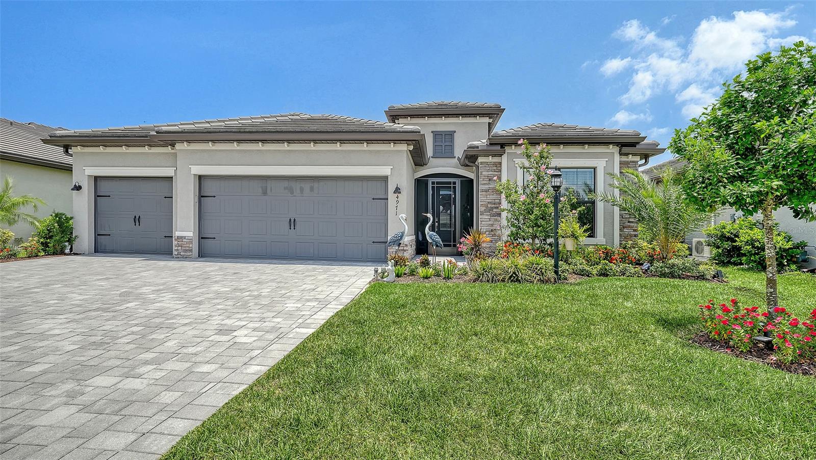 Model-perfect home that is truly move-in ready! This immaculate residence features countless upgrades and designer touches throughout. Enjoy beautiful lake views, a fully fenced backyard, and a spacious 3-car garage. The owners are currently expanding the lanai,   27x25,  creating even more outdoor living space to enjoy Florida's year-round sunshine.  Experience resort-style living with lawn maintenance and 24-hour gated security included.  Recent upgrades include new LG front Load washer and dryer with 5 yr warranty and a new LG Stainless Steel 4 door French refrigerator with 5 yr warranty.  Gutters have been added to entire home and entire interior walls have been newly painted and as we speak a new extended screened lanai with No See Um Screens. 
 
Exceptional community amenities include a resort pool, lap pool, full-service restaurant, tiki bar, fitness center, pickleball, tennis, volleyball, and a full calendar of social activities.

Whether you're looking for relaxation, recreation, or the ultimate Florida lifestyle, this exceptional home offers it all. Don't miss this!