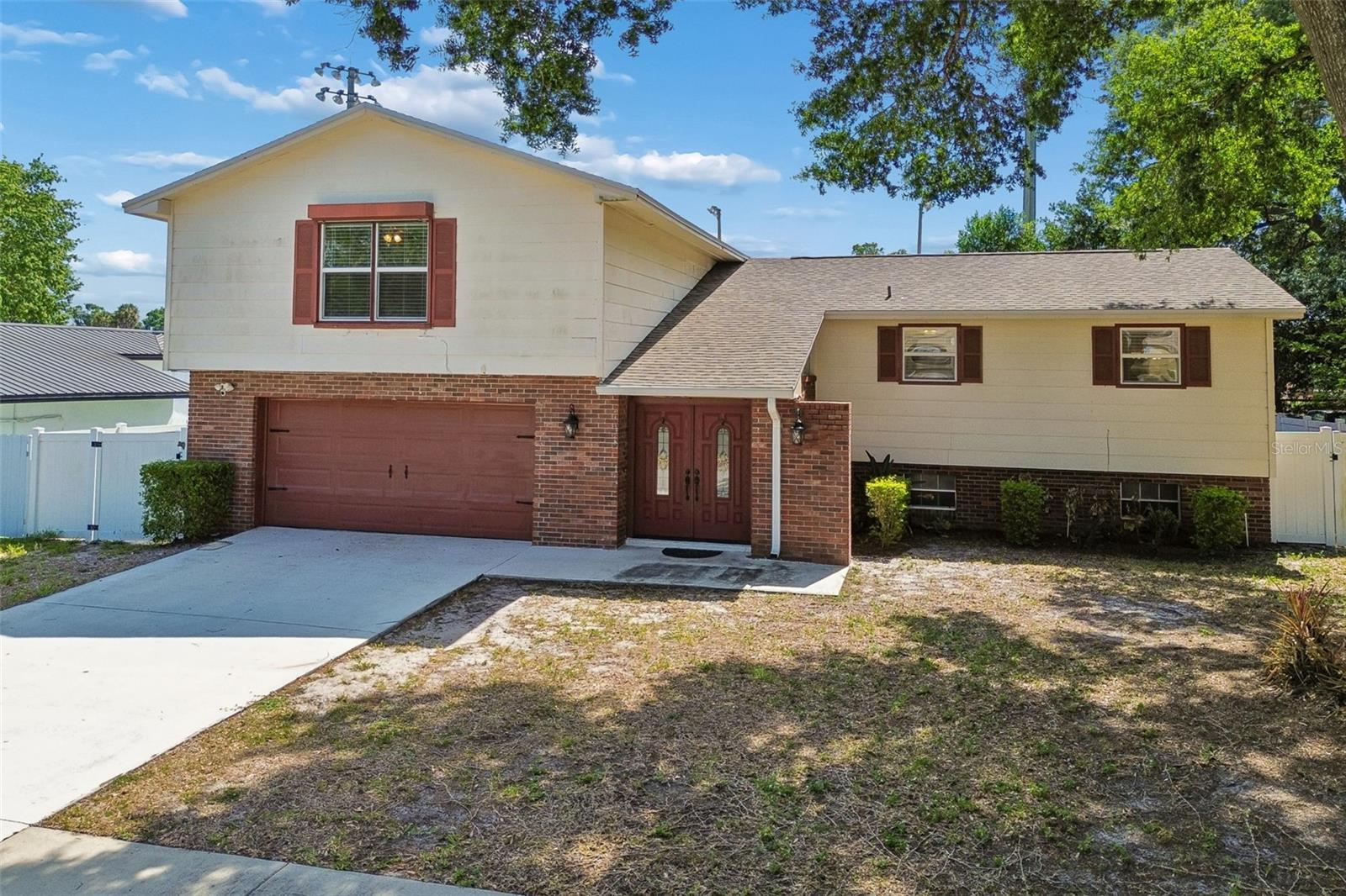 Welcome to Brandon Groves, conveniently located just outside of Tampa in a quiet, established neighborhood just blocks from the North Brandon YMCA and North Brandon Sports Complex. With NO HOA, NO CDD fees, and NO flood zone, this property offers the kind of flexibility and peace of mind that is hard to find. Set on a spacious 0.22-acre lot, this POOL and SPA home features over 2,400 square feet of living space with a thoughtfully designed split-level floor plan that provides room for everyone. As you arrive, the two-car garage and mature surroundings set the tone for what’s inside. Step through the front door to find formal living and dining spaces that flow seamlessly into the oversized kitchen, complete with plenty of room for an eat-in breakfast area, making it the perfect setup for both everyday living and entertaining. The main level opens to an elevated deck overlooking a truly impressive outdoor space. Down below, a massive 56’ x 40’ patio surrounds the 17’ x 32’ pool and spa, creating your own private backyard retreat. Whether you’re hosting, relaxing, or just enjoying Florida living, this space delivers. The lower level of the home sits at pool level and offers a cozy secondary living room with a fireplace, a dedicated office, and a half bath. French doors lead directly out to the pool area, blending indoor and outdoor living effortlessly. Upstairs, the owner’s suite along with three additional bedrooms and a full bathroom provide a private retreat, with new hardwood flooring throughout the second floor adding a fresh, updated feel. Step outside through French doors to the large screened-in lanai, where the pool and spa overlook a fully vinyl-fenced backyard, offering both privacy and functionality. The home also backs up to the North Brandon Youth Baseball fields, giving you open views with no rear neighbors directly behind. Major updates have already been taken care of, including a new roof in 2025, pool resurfaced in October 2021, and newer windows, allowing you to move in with confidence. Beyond the home itself, the location offers the perfect balance of peaceful suburban living and everyday convenience. Situated just minutes from Interstate 4 and Interstate 75, commuting into Tampa, Brandon, or surrounding areas is effortless. Nearby, you’ll find shopping, dining, and entertainment at Westfield Brandon Mall. For outdoor lovers, Eureka Springs Conservation Park is just a short drive away, offering lush gardens, walking trails, and a quiet escape into nature. You’re also within easy reach of Downtown Tampa, where you can enjoy the Riverwalk, waterfront dining, sporting events, and nightlife, while still being close enough for weekend trips to the Gulf beaches or Tampa International Airport. This home offers the space, updates, and location to truly have it all, schedule your showing today!