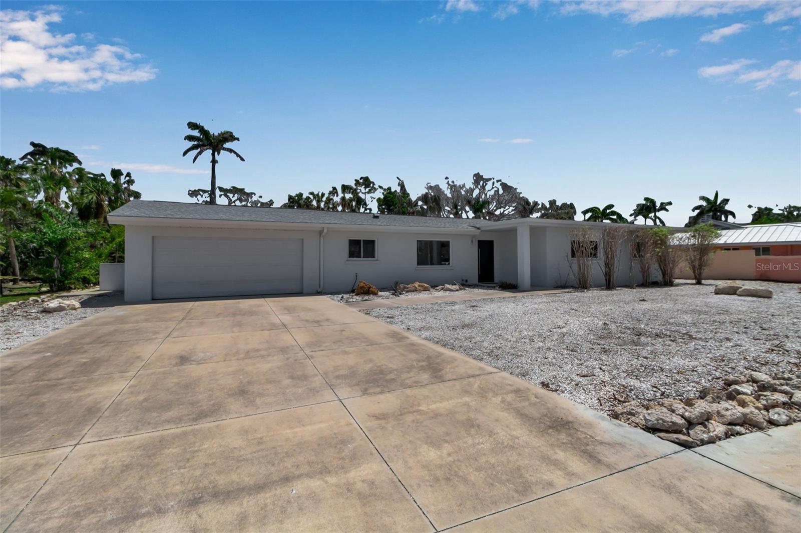 Virtually Staged. Charming Mid-Century Ranch on Saint Armands | Oversized Lot. Welcome to your slice of paradise on the coveted Saint Armands in Sarasota, Florida. This sturdy mid-century ranch home offers the perfect blend of timeless character and modern comfort. Situated on an oversized lot, this 3-bedroom, 2-bathroom residence provides ample space for relaxation, entertaining, or future expansion. Step inside to discover a natural light-filled floor plan with classic mid-century details and an inviting atmosphere. The generous living area with vaulted ceilings flows seamlessly, creating a warm, welcoming environment ideal for both everyday living and entertaining guests. Enjoy peace of mind with major updates already in place, including a newer roof (2021) and HVAC system (2023)—ensuring comfort and efficiency for years to come. Outside, the expansive yard offers endless possibilities—from 2 existing outdoor hot water showers to lush landscaping and outdoor dining spaces to room for a pool or garden oasis. Just a short stroll to the boutiques and dining of Saint Armands Circle and minutes to the pristine shores of Lido Beach, this home is perfectly positioned to enjoy the best of coastal Sarasota living. Don’t miss this rare opportunity to own a classic gem in one of Sarasota’s most desirable neighborhoods. Private showings available.