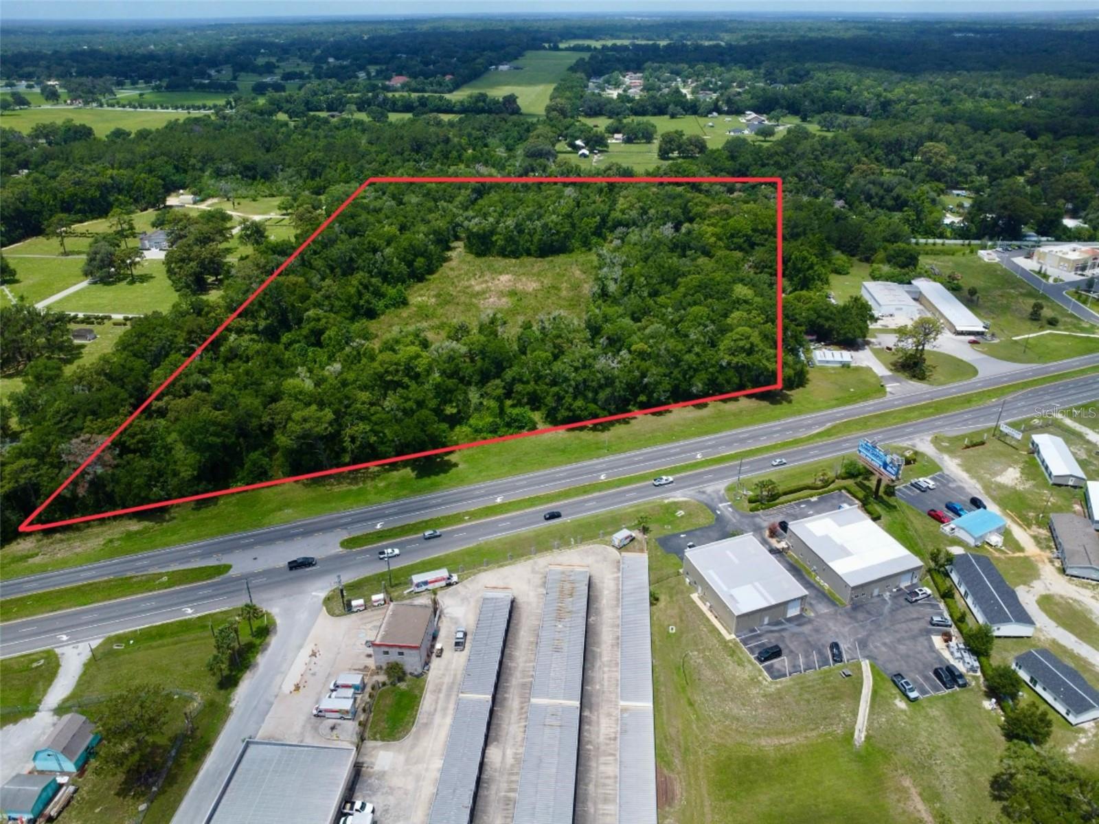 Positioned along highly traveled Pine Street/US Hwy 301/Hwy 27 & Hwy 441 in the heart of Ocala, this exceptional 23.26-acre commercial vacant property (Zoned B4) for sale offers endless possibilities for development and investment. With outstanding highway frontage and excellent visibility, this prime location provides easy access for both local traffic and travelers moving through one of Central Florida’s fastest-growing areas. Per FDOT there is an estimated 30,000 Average Annual Daily Traffic count. Whether you envision retail, office space, mixed-use development, hospitality, or a larger commercial venture, this expansive parcel offers the flexibility and exposure needed to bring your vision to life. The property’s strategic location places it near established businesses, residential communities, and major transportation routes, making it an ideal opportunity for investors, developers, and entrepreneurs alike. There is also a second access point located off of SE 21st Avenue to the northwest side of the property. With Ocala continuing to experience rapid growth and economic expansion, opportunities like this are becoming increasingly rare. Take advantage of the high-traffic location, strong development potential, and the chance to secure a substantial commercial footprint in a thriving market. Don’t miss this opportunity to invest in the future of Ocala. Call today for more information!