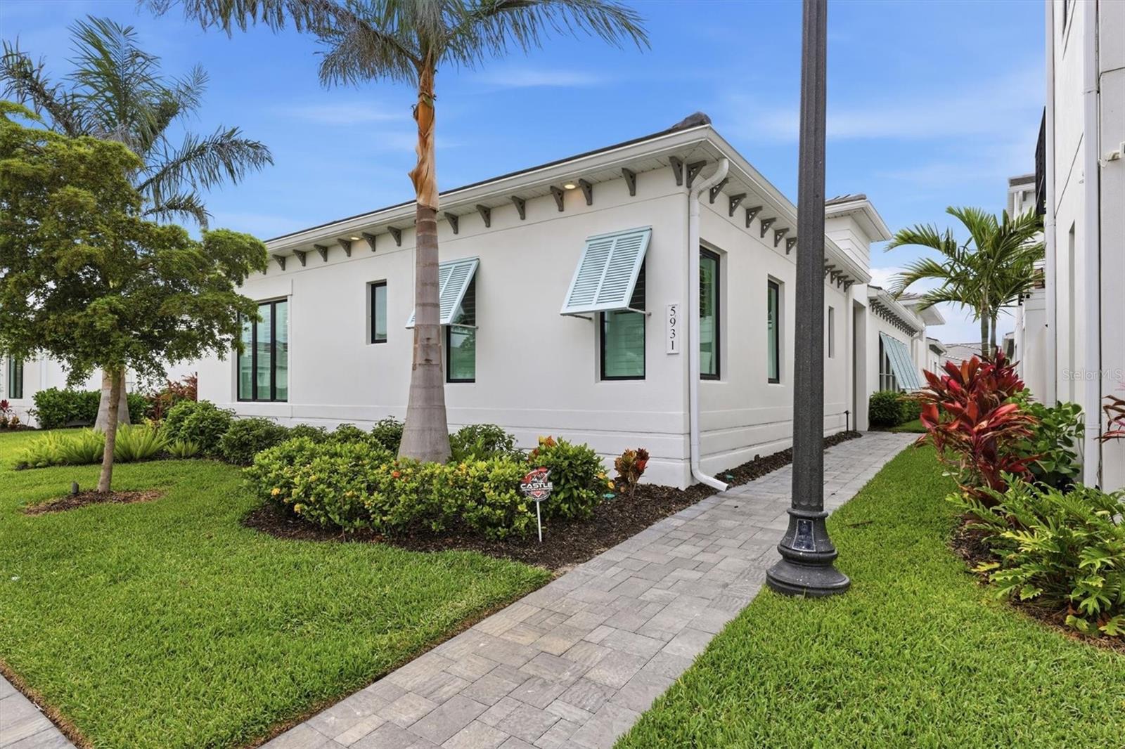 Welcome to Aqua Lagoon and this upgraded Sea Grape model, completed in 2024 and enhanced beyond the builder’s standard plan. Featuring approximately $300,000 in owner and builder upgrades, this home offers expanded living space, upgraded finishes, and a thoughtfully designed layout throughout.
This customized Sea Grape plan includes approximately 250 additional square feet compared to the standard layout, achieved through structural enhancements that expanded both the living room and courtyard. The single-level floor plan includes three bedrooms, three full bathrooms, a two-car garage, and enhanced indoor-outdoor living spaces. The great room features 14-foot ceilings, while the remaining living areas have 10 to 11 foot ceilings with tray details.
The open-concept layout connects the great room, dining area, and kitchen, creating a natural flow between the primary living spaces. The kitchen includes an expanded island that increases both workspace and seating. Large-format 2x2 ft tile flooring extends throughout the home, while upgraded sliding glass doors provide abundant natural light and direct access to the private courtyard and pool. Serving as the focal point of the home, the courtyard is accessible from multiple living areas and extends the usable living space outdoors. Additional enhancements include an extended garage, spray-foam insulation with a non-vented attic, and a wide range of interior and structural upgrades.
The split-bedroom design provides privacy and flexibility. The owner’s suite includes dual vanities, a soaking tub, walk-in shower, and a large walk-in closet. A second ensuite bedroom is located on the opposite side of the home, while a third bedroom or bonus room adjacent to the primary suite offers options for guests, office use, fitness, or play space.
Located within the gated Aqua community, residents have access to a 4-acre tropical lagoon designed for swimming, paddleboarding, kayaking, and shoreline relaxation. The property is minutes from IMG Academy and within convenient reach of Gulf beaches, Sarasota, and downtown Bradenton. Low HOA dues include fiber internet, TV, and landscaping for a low-maintenance ownership experience.
The flexible floor plan, extensive upgrades, and community amenities support a variety of ownership uses, including full-time residency, seasonal occupancy, or investment.