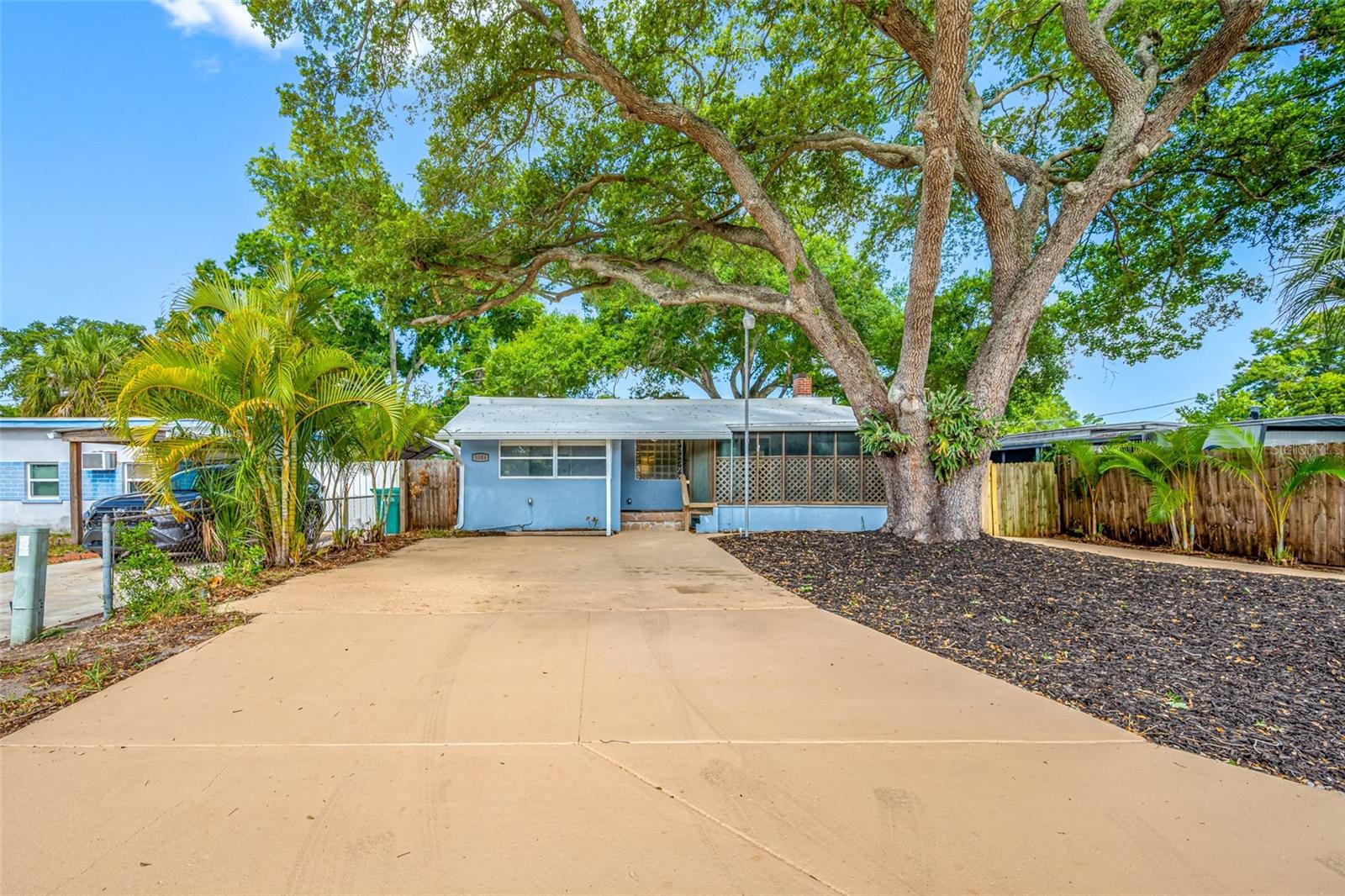 Welcome to 5044 Betty Street N, a beautifully updated modern home nestled near the end of street with no through traffic. Surrounded by mature trees and lush greenery, this property offers a cool, inviting atmosphere. Thoughtful updates throughout create a move-in-ready opportunity that blends style, comfort, and functionality. The home is outside of the flood zone and has no HOA, helping to keep insurance and ownership costs low. The property is in unincorporated Pinellas County, which allows adding ADUs and short-term rentals, providing flexible options for a new homeowner or experienced investor.

From the covered front entry, you are welcomed into a bright foyer that doubles as a convenient mudroom and laundry area, complete with a pocket door to help minimize noise. Luxury vinyl plank flooring flows throughout the home, offering both durability and water resistance. The updated kitchen features granite countertops, stainless-steel appliances, shaker cabinets with soft-close doors, and a built-in breakfast bar that opens to the living room, creating an ideal space for everyday living and entertaining. The living room is centered around an electric fireplace with adjustable colors and heat settings, adding warmth and ambiance year-round. Sliding glass doors open to a spacious screened front porch, providing a comfortable outdoor retreat to enjoy the fresh air with a cold drink or hot cup of coffee.

The home offers three bedrooms and two full bathrooms. The primary suite includes a walk-in closet with custom-built-in shelving that opens through to the private en-suite bathroom featuring marble tile and a glass-enclosed shower. The guest bathroom is conveniently located between the other two bedrooms and includes an upgraded vanity, marble tile finishes, and a tub with shower. The third bedroom has a built-in closet, abundant natural light, and sliding glass doors opening to the rear deck. This room is currently furnished as a home office but could also be a great game room or home gym.

Outside, the fully fenced backyard provides privacy and plenty of room to enjoy the outdoors. A 20-foot-wide rear deck wraps half the home, and extends out to a detached workshop, creating an excellent setting for outdoor gatherings, projects, and hobbies. The spacious workshop includes a built-in desk and an attached storage closet for added convenience. The oversized driveway provides parking for four vehicles, plus additional space for a boat or RV. Situated on a generous 50-by-106-foot lot, this thoughtfully updated property offers a rare combination of modern upgrades, outdoor living space, and flexibility in a highly convenient location.

Within approximately 10 minutes, you'll find Boca Ciega Bay, Bay Pines, the VA campus, Seminole Lake, tennis and pickleball facilities, multiple parks, public boat ramps, shopping, and dining options. St. Pete Beach and Madeira Beach are both just a short drive away and are only two of the many popular Gulf Coast destinations nearby. 

Additional improvements include an energy-efficient TPO roof installed in 2019, a new electrical panel installed in 2022, A/C 2019, and Sentricon termite prevention system along with quarterly pest control service that has been consistently maintained by the owner. This property delivers the perfect blend of modern comfort, outdoor enjoyment, and convenient access to everything the area has to offer.