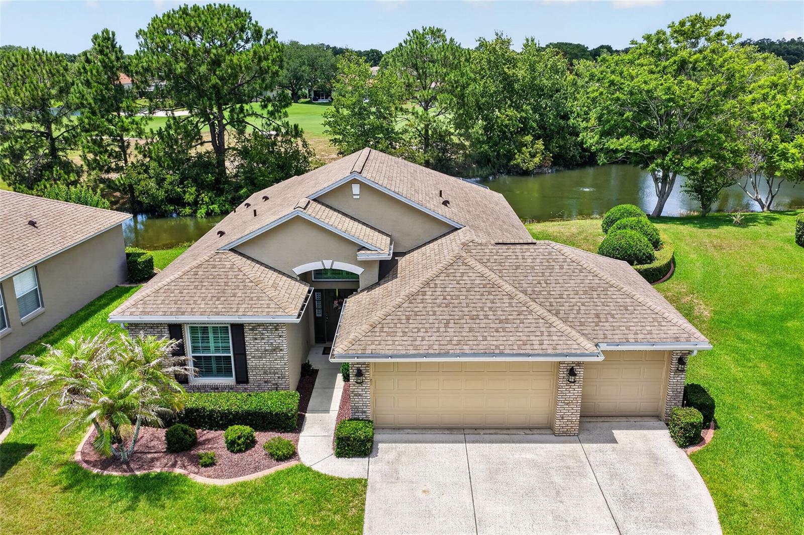 Located in The Country Club of Mount Dora, this home offers panoramic views of the pond and golf course. The home has approximately 100 feet of waterfront and is situated on a quiet cul de sac.  The open concept floor plan offers views from almost every room. Great care has been taken in completely updating the home and expanding the original floorplan. Features include: plantation shutters, engineered wood flooring, crown molding, double-paned windows (Replaced in 2016),a large, screened lanai with non-slip Shark coating on floor and a three-car garage. The roof was replaced in 2020 and the HVAC system in 2022. Lawncare is provided for easy, maintenance-free living. Come see this home today and start enjoying the country club lifestyle. Golf, pickleball, tennis, pool and member dinners and events are offered with membership to The Country Club of Mount Dora. The community is located minutes away from historic downtown Mount Dora, which offers charming shops, restaurants and lake front activities.